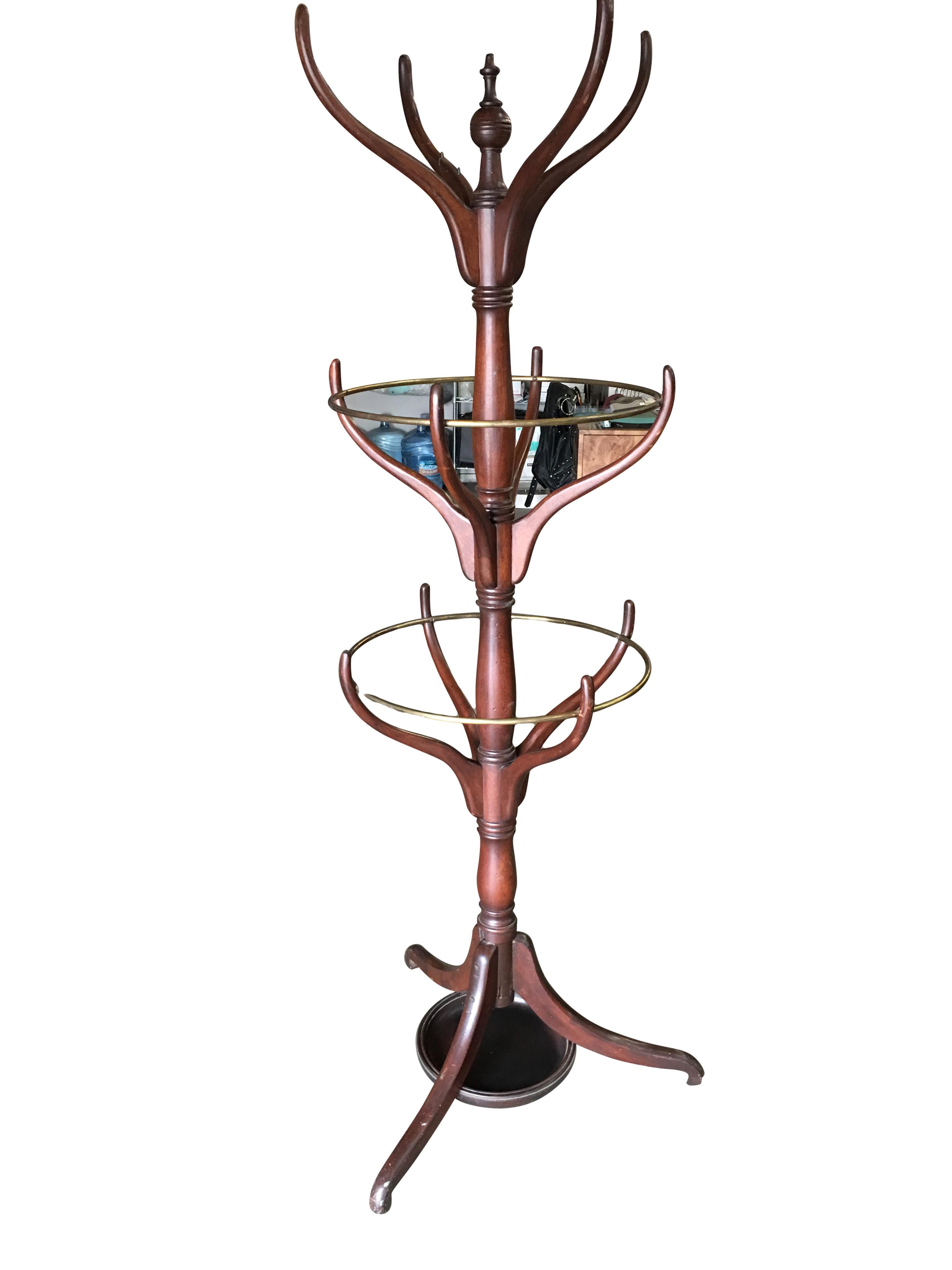 Early 20th century mahogany hall tree with brass hardware featuring placement for coats, hats, as well as umbrellas and canes.