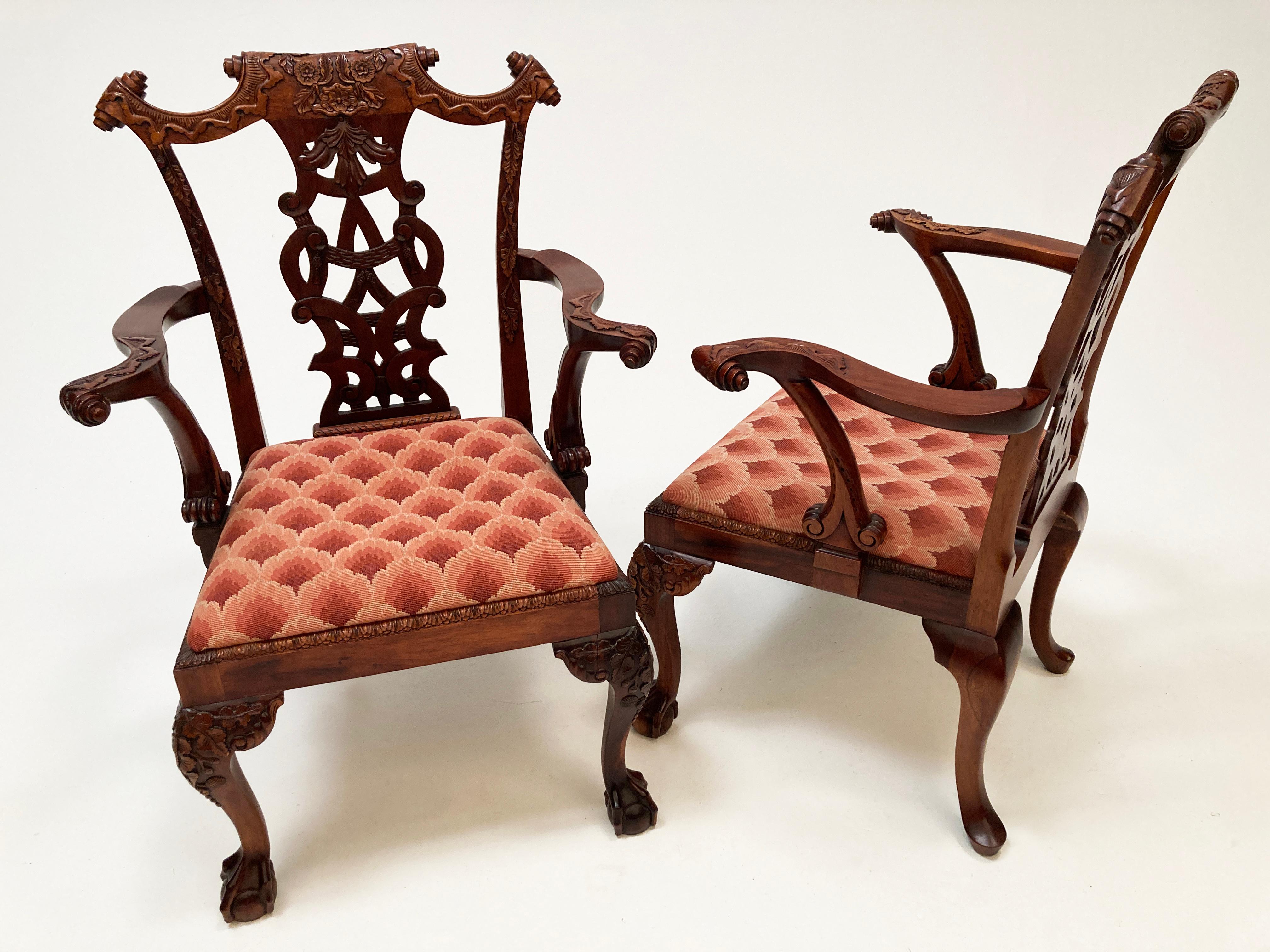 These two Mahogany Antique Irish Chippendale replicas are nothing short of breathtaking. Those with discriminating taste will recognize that from the exceptional hand carved work covering the chairs' frames to the parchment scroll on the crest rail,