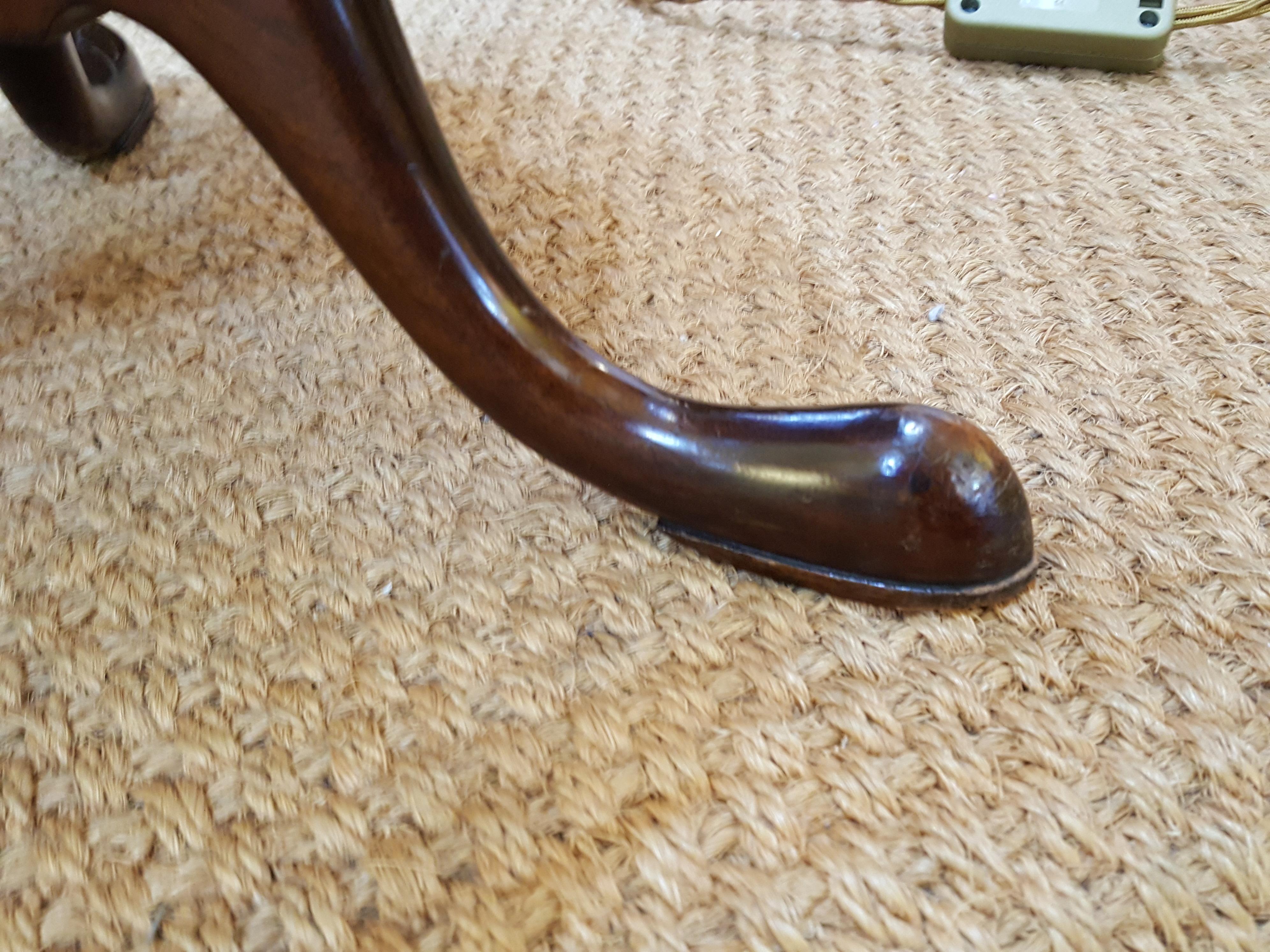 Early 20th century mahogany wine table with tripod leg, pad feet and turned, carved twist column. Measures: 12