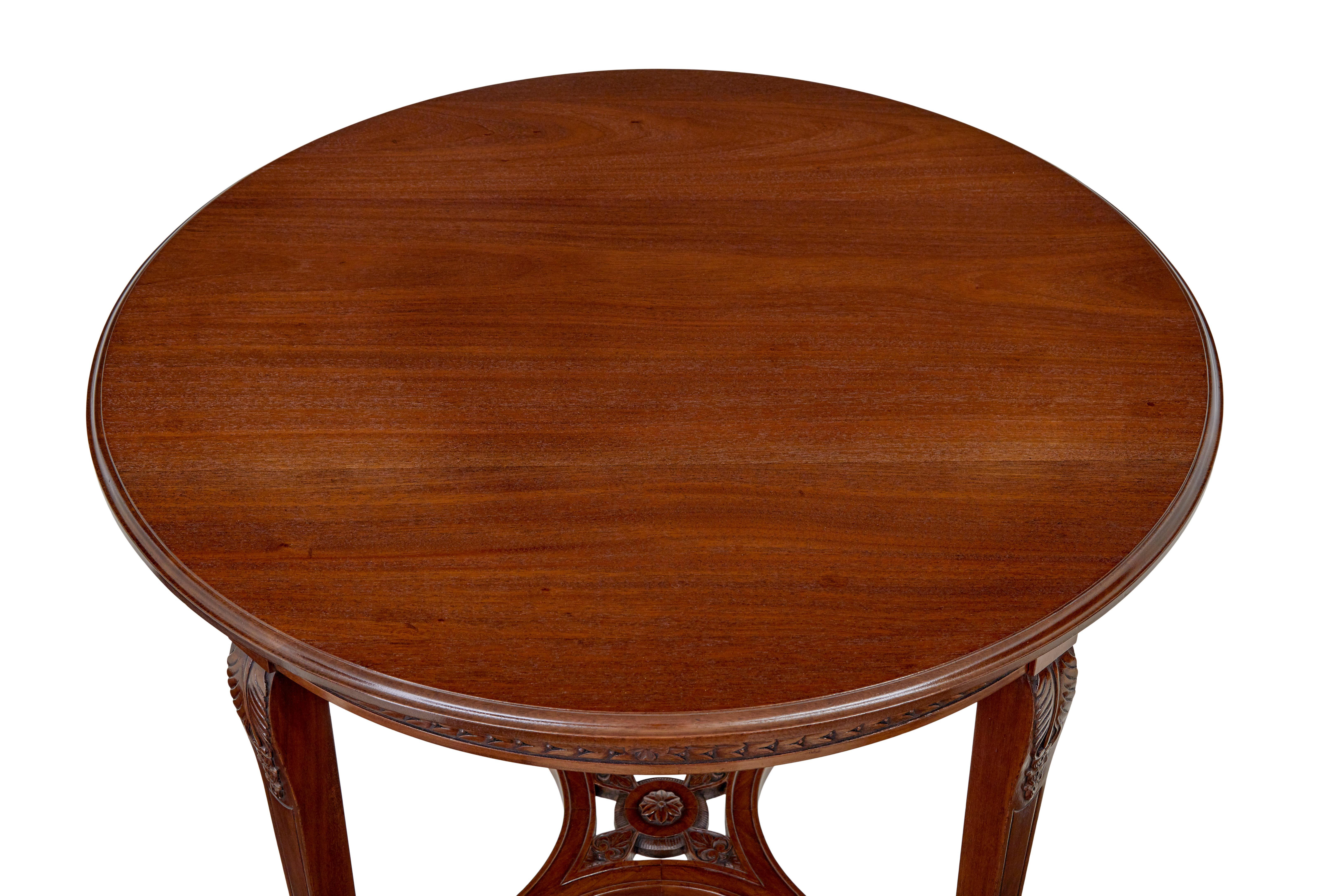 Early 20th century mahogany round center table circa 1920.

Good quality multi purpose table for around the home, round 3 plank top with molded edge.  Decorated with carved leaves around the apron and roundels on each quarter ( 1 missing roundel as