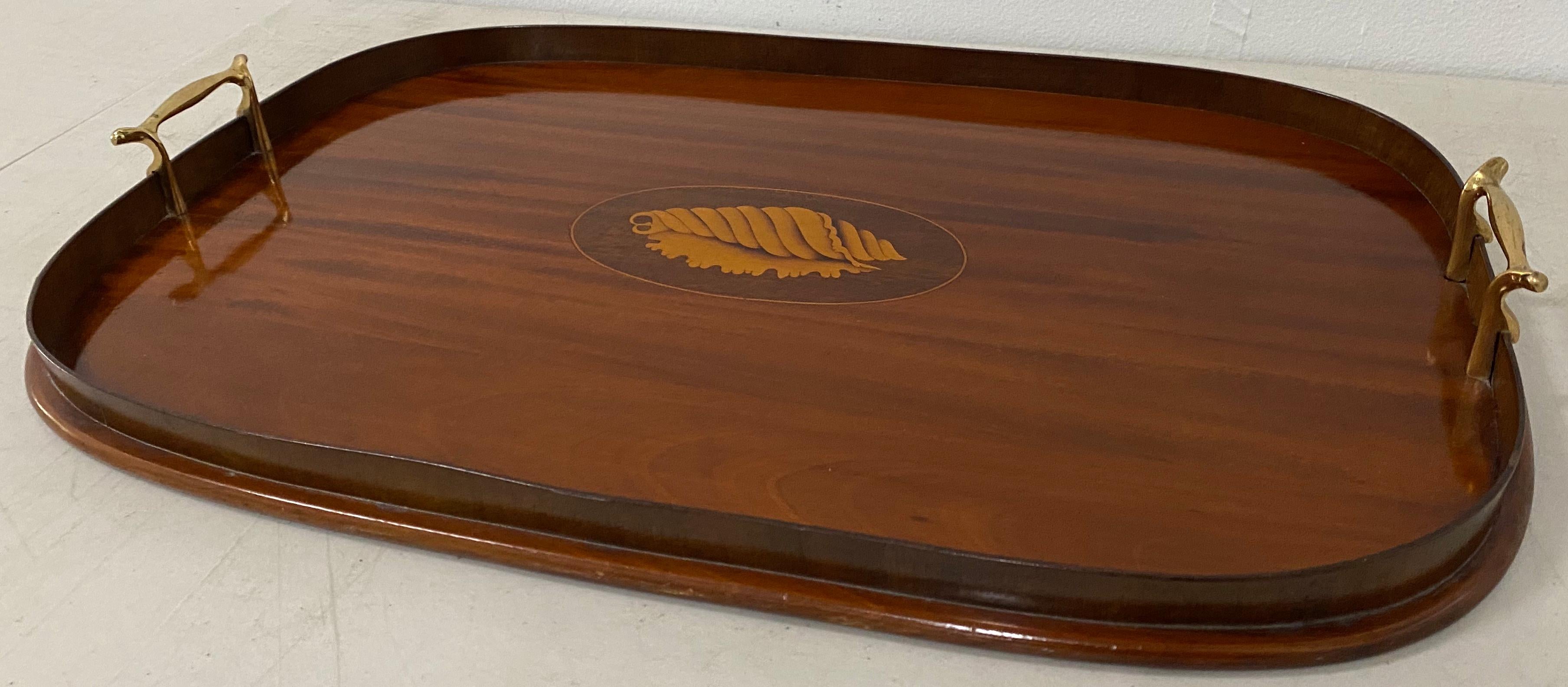Early 20th century mahogany serving / bar tray with shell inlay

Gorgeous handcrafted serving tray. Made with old growth mahogany with maple inlay.

The serving tray is in excellent condition, but could use some new felt strips on the bottom