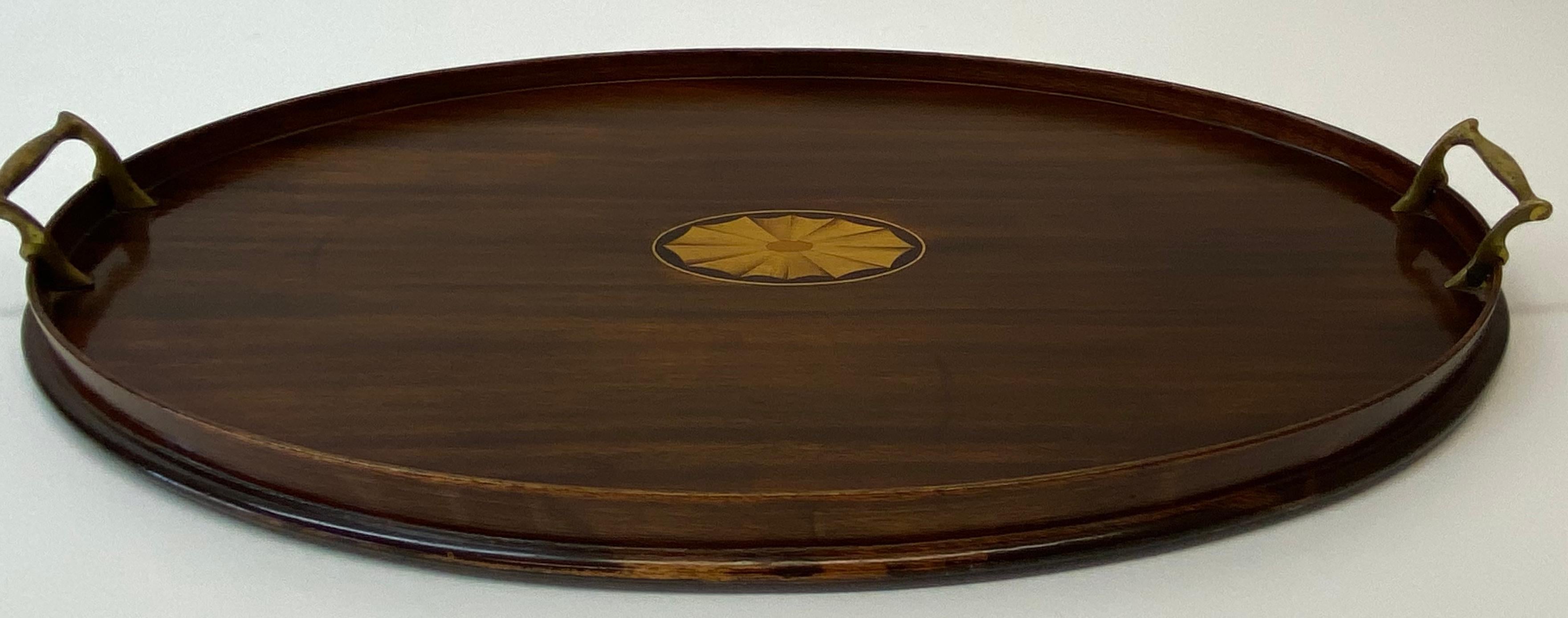 Early 20th century mahogany serving tray w/ walnut inlay c.1910

A fine antique serving / bar tray for your favorite bottles and glasses

Measures: 24