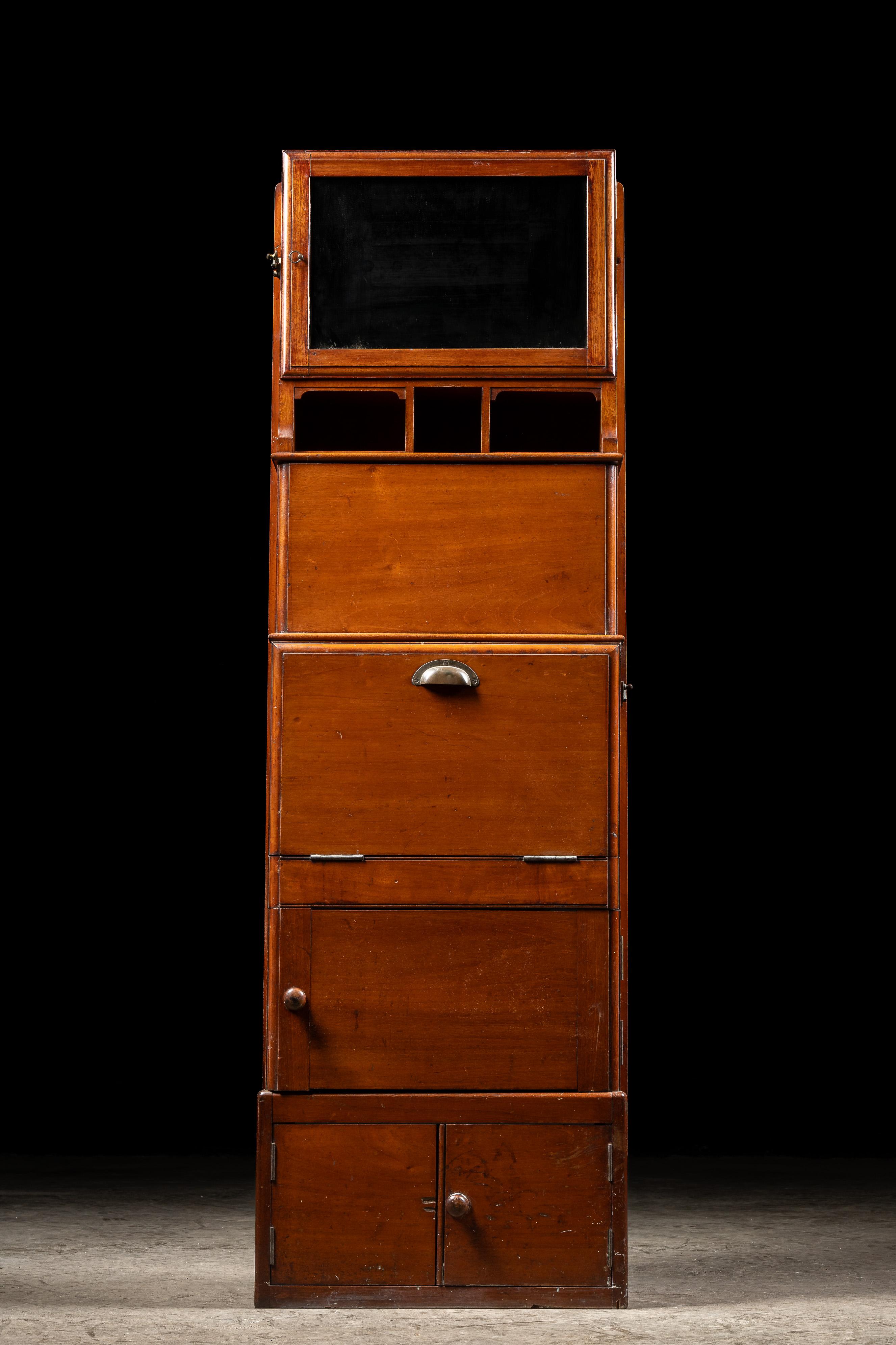 c. 1900s

Antique wooden ship dresser stand.

This unique piece was once a common sight on period passenger ships and trains. Manufactured to be an all-in-one design, it features both storage and vanity functions. A small cabinet with shelving at