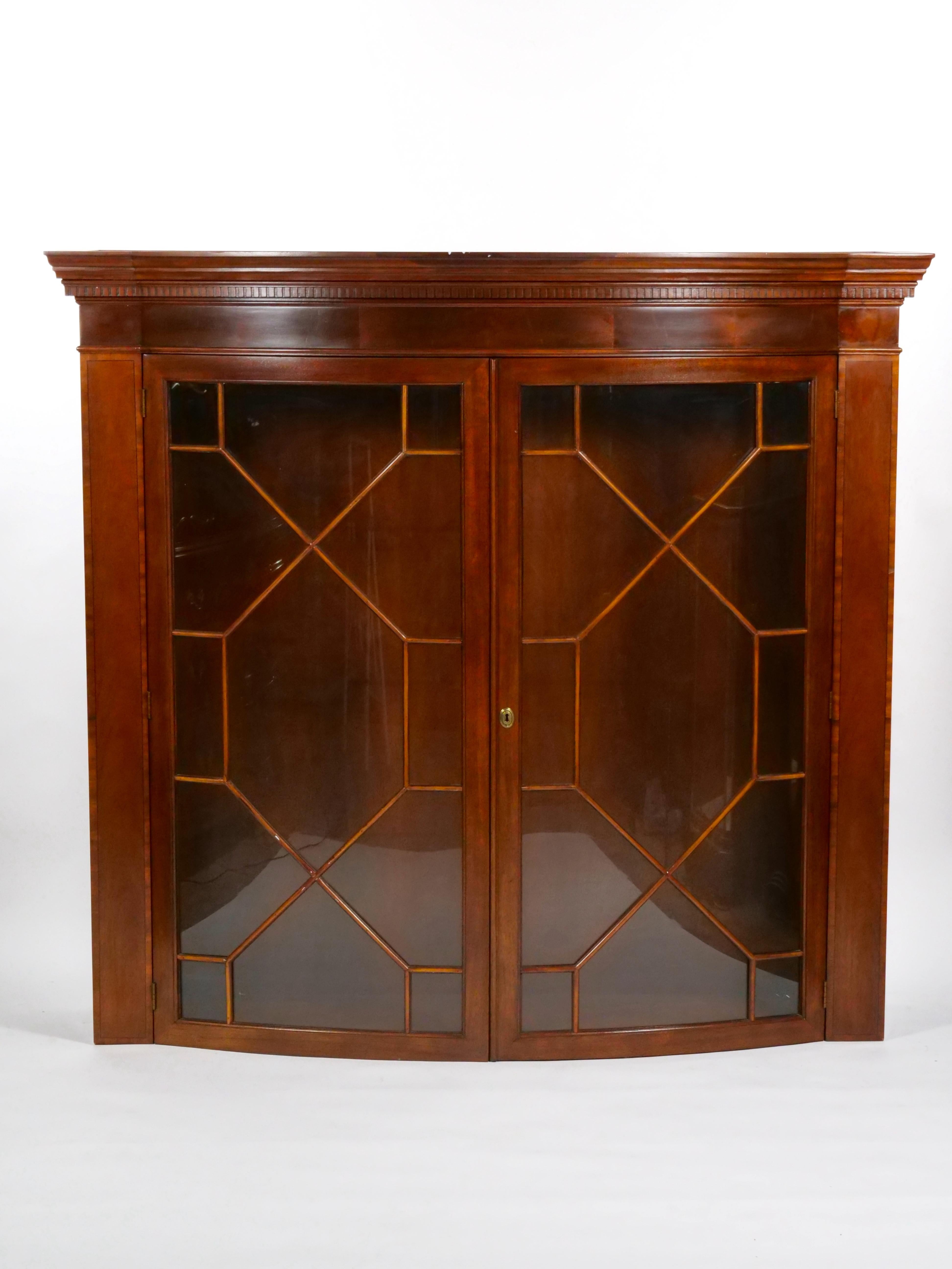 Add a touch of historical charm to your space with this North American Early 20th Century Mahogany Wood Demilune Shape China Cabinet, a remarkable piece of furniture that reflects the craftsmanship and design of the era. The charleston inlaid and