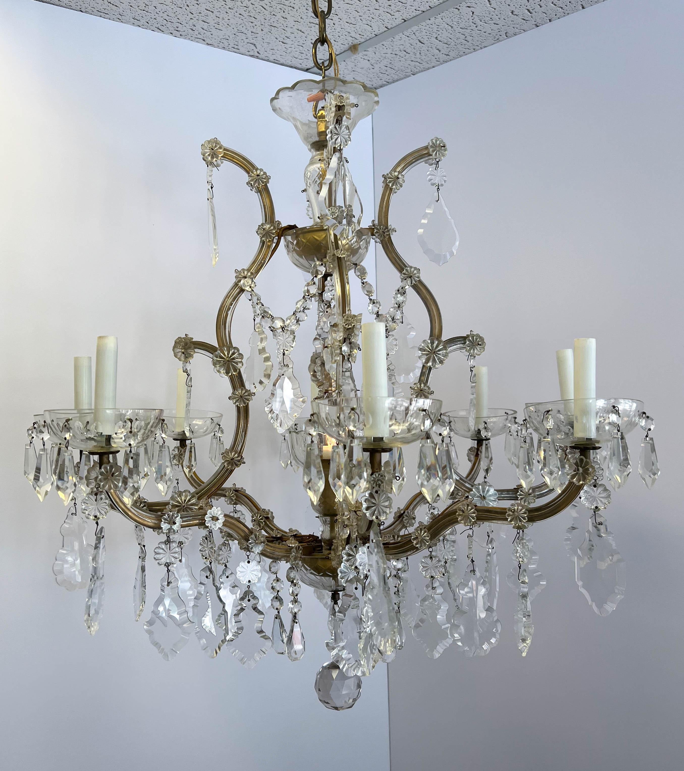An exquisite antique eight-arm Maria Theresa chandelier made in Italy. Maria Theresa chandeliers, named after Austria’s Empress Maria Theresa, are antique crystal lighting fixtures popular worldwide for their outstanding beauty, baroque styling, and