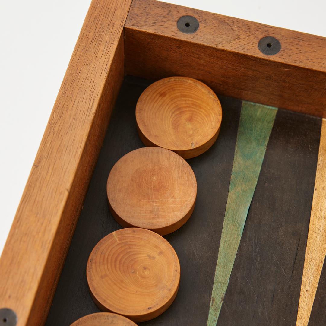 - This gorgeous antique backgammon set features an original marquetry board, made by hand in France in the early 20th century.

- The inlaid wood gameboard was crafted by hand from solid walnut using traditional tongue and groove methods. Its brass