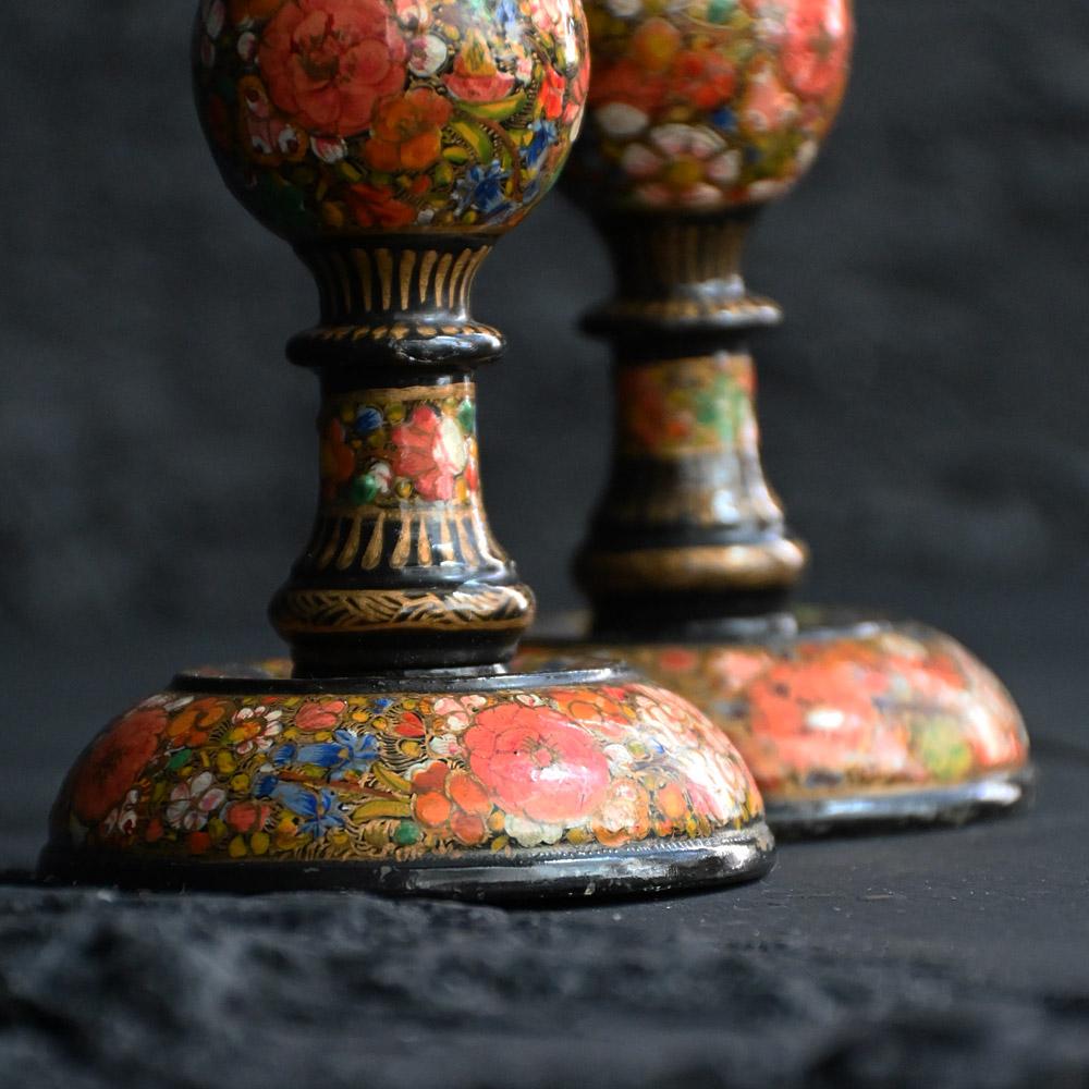 Early-20th Century Matched Pair of Kashmiri candle sticks 
A highly decorative matched pair of early 20th Century Kashmiri hand painted candle sticks. With detailed floral pattern and lacquered finish. 
Origin: Kashmir 
Material: Wood 
Age: