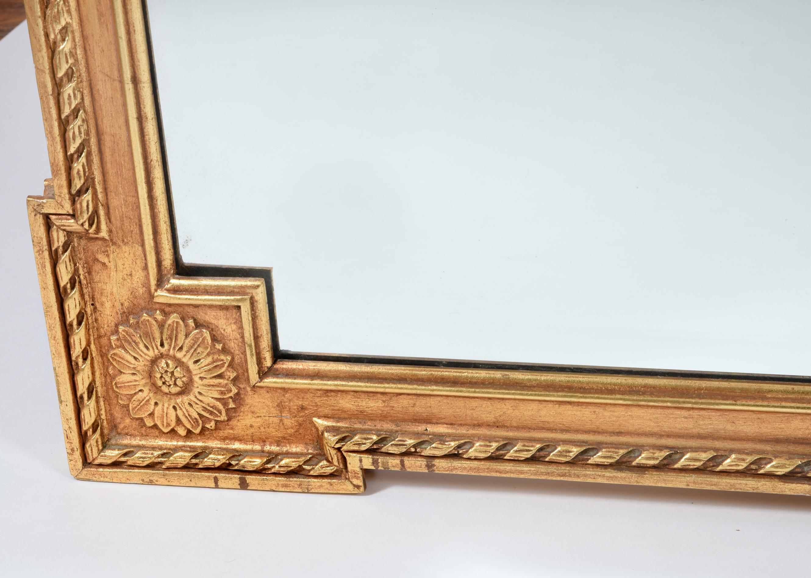 Early 20th century matching pair giltwood frame beveled hanging wall mirror. This Mirror is just exquisite and in excellent vintage condition. The mirror have a beautiful wreath crests top and all around design details. The Mirror measure about 46