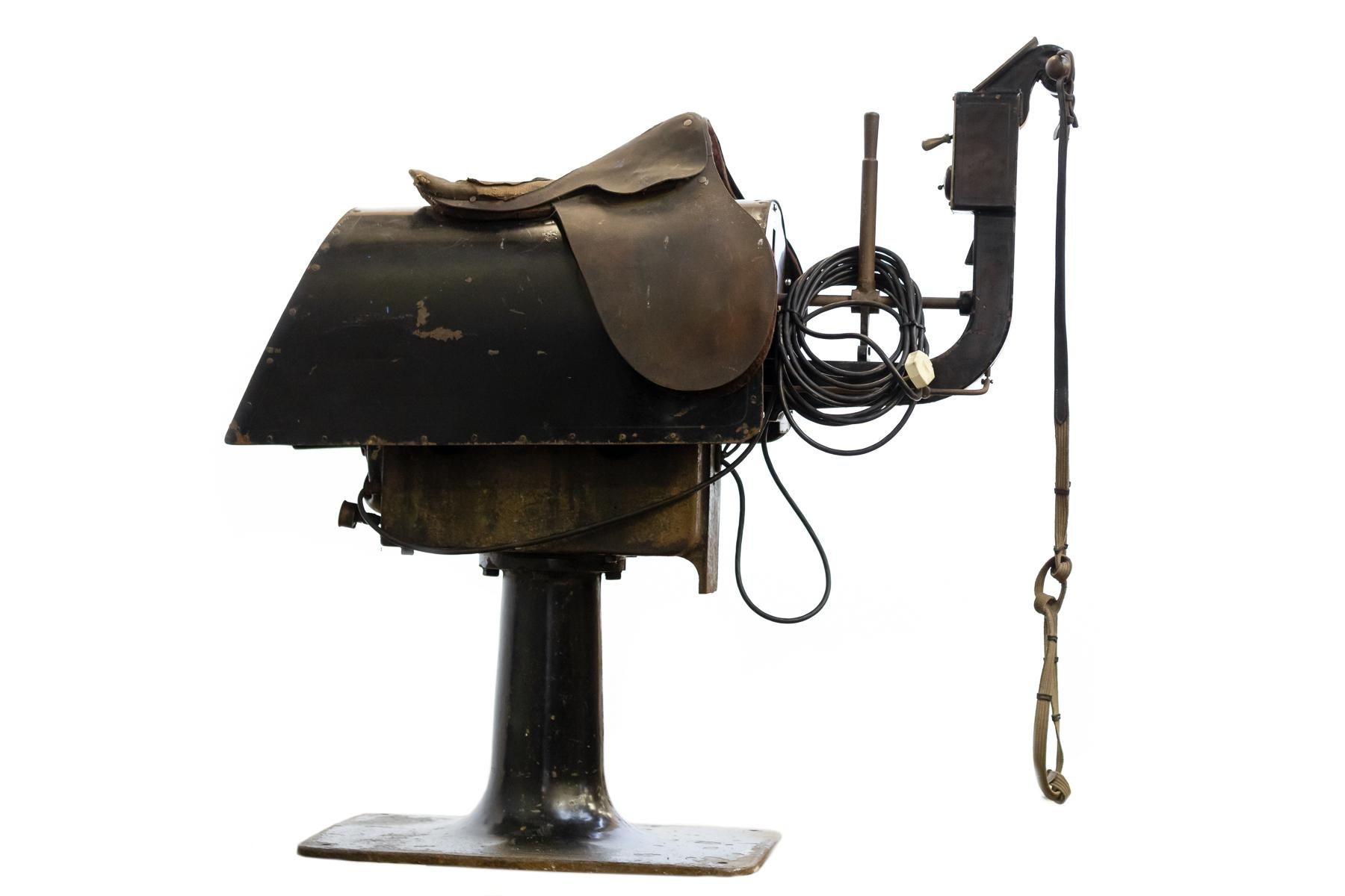 A wonderful, rare and unusual exercise machine in the form of a mechanical horse. The cast iron frame houses a three speed electric motor that moves the 
