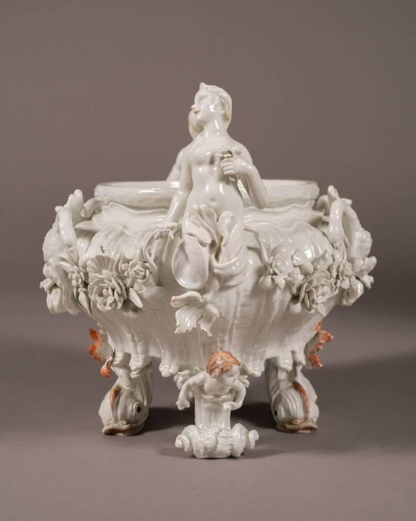 Early 20th century Meissen porcelain centerpiece 

Germany, circa 1910

Having two maidens on either side of the centerpiece over semi colored dolphins

Dimensions: Height 13