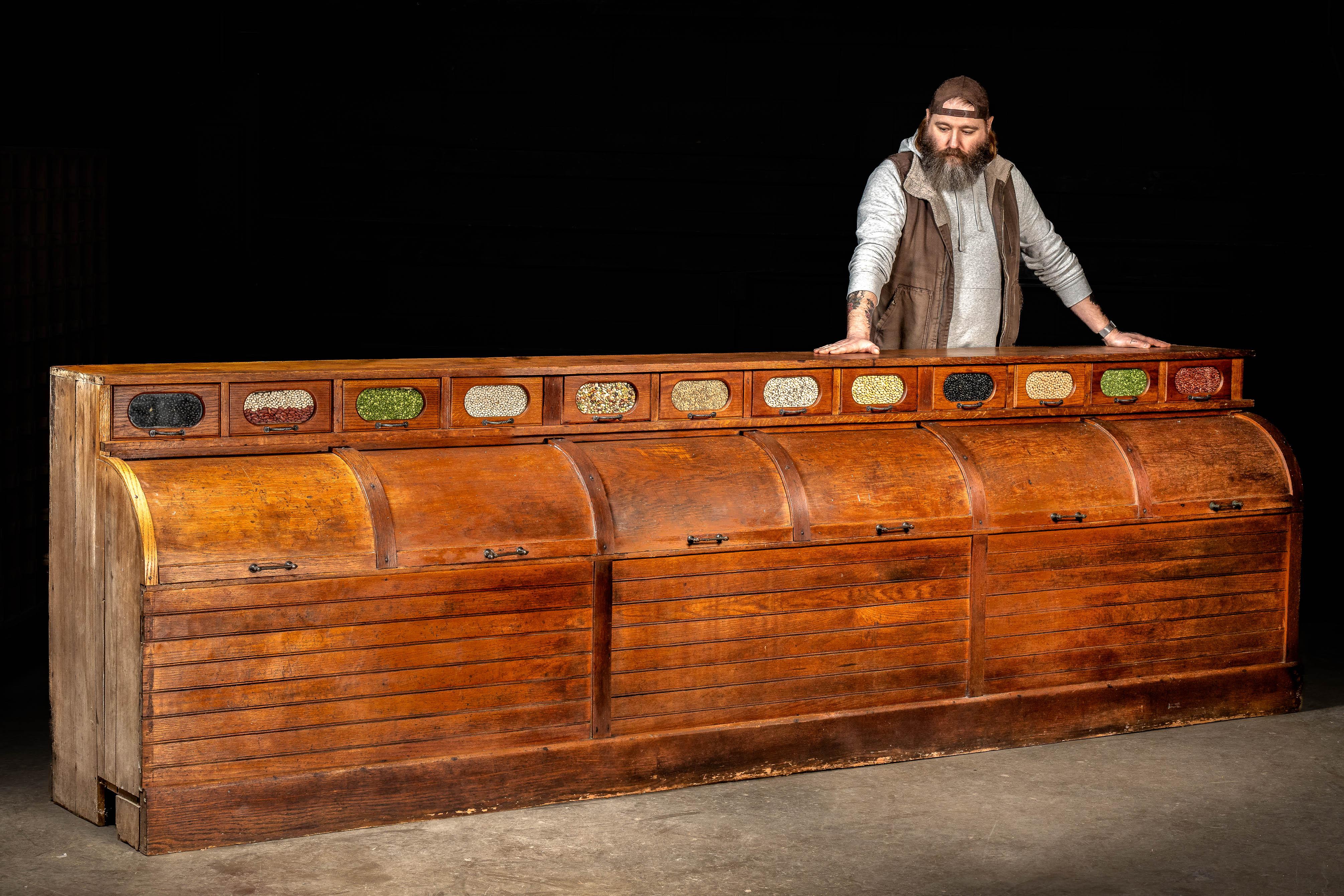 1909; possibly Charles K. Fox Co. or Parnall & Sons, Ltd.

Antique oak seed or grain counter with rolltop doors.

This piece was designed to allow customers in general and feed stores to gather their own grains or seeds (depending on the stock). A
