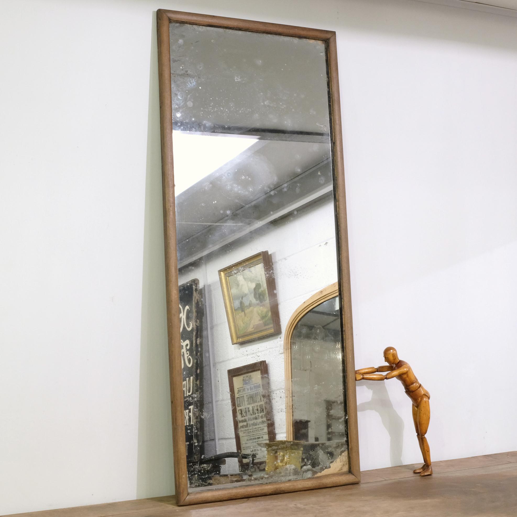 Antique mirror with simple oak frame and original mercury plate. The glass shows lots of characterful ageing, interestingly in places revealing old newspaper backing. Can be hung portrait or landscape, circa early 1900s.

Free shipping offered to