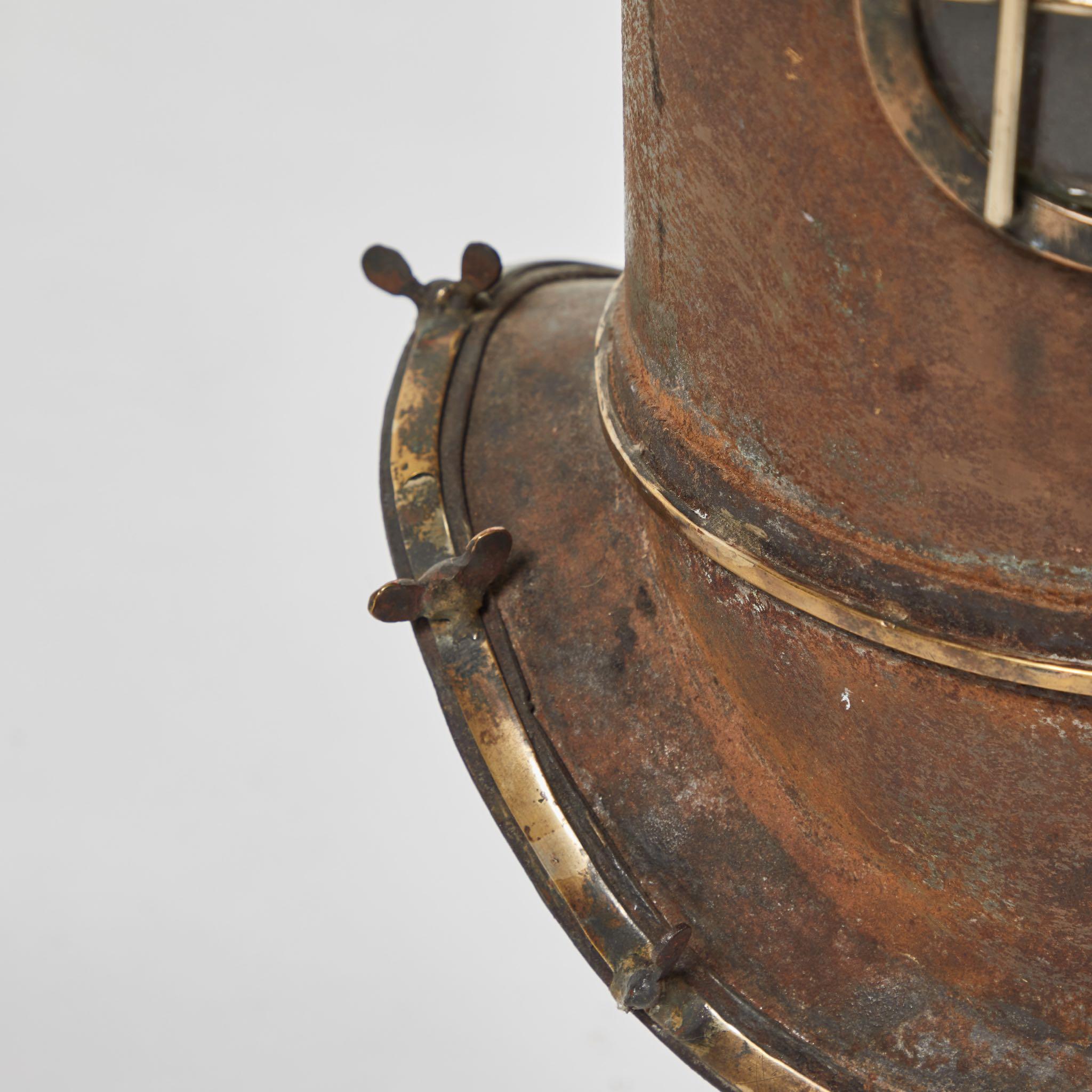 Metal diver helmet on stand, originating in England, circa 1920.