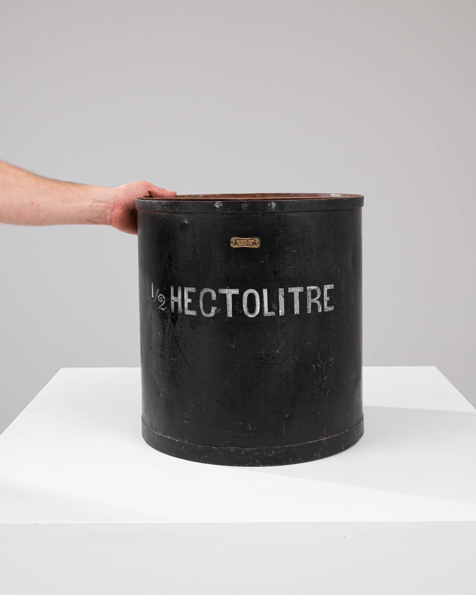 Discover a piece of history with this authentic Early 20th Century Metal Measure, a testament to the storied past of craftsmanship and trade. With a capacity of 1/2 hectolitre, this sturdy container was once a standard in measuring goods, and it