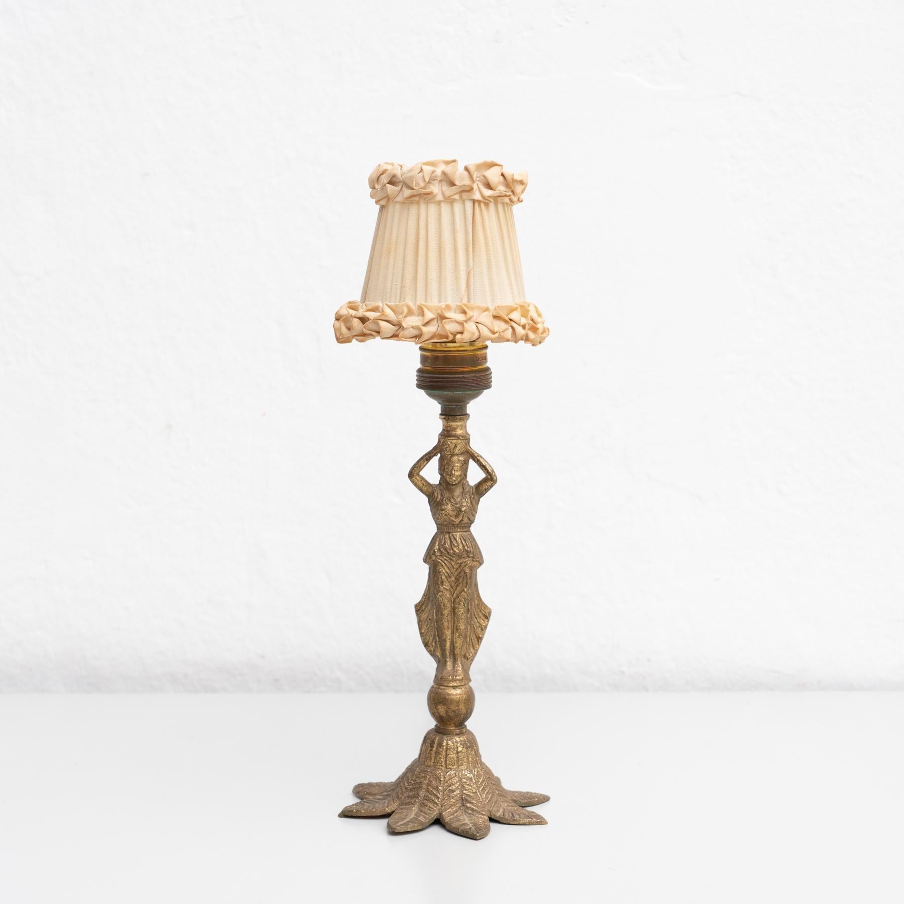 Early 20th century table lamp, with a beautiful decoration of a woman and a screen.    Manufactured by unknown designer in Spain.    In original condition, with minor wear consistent with age and use, preserving a beautiful patina.    Materials: 