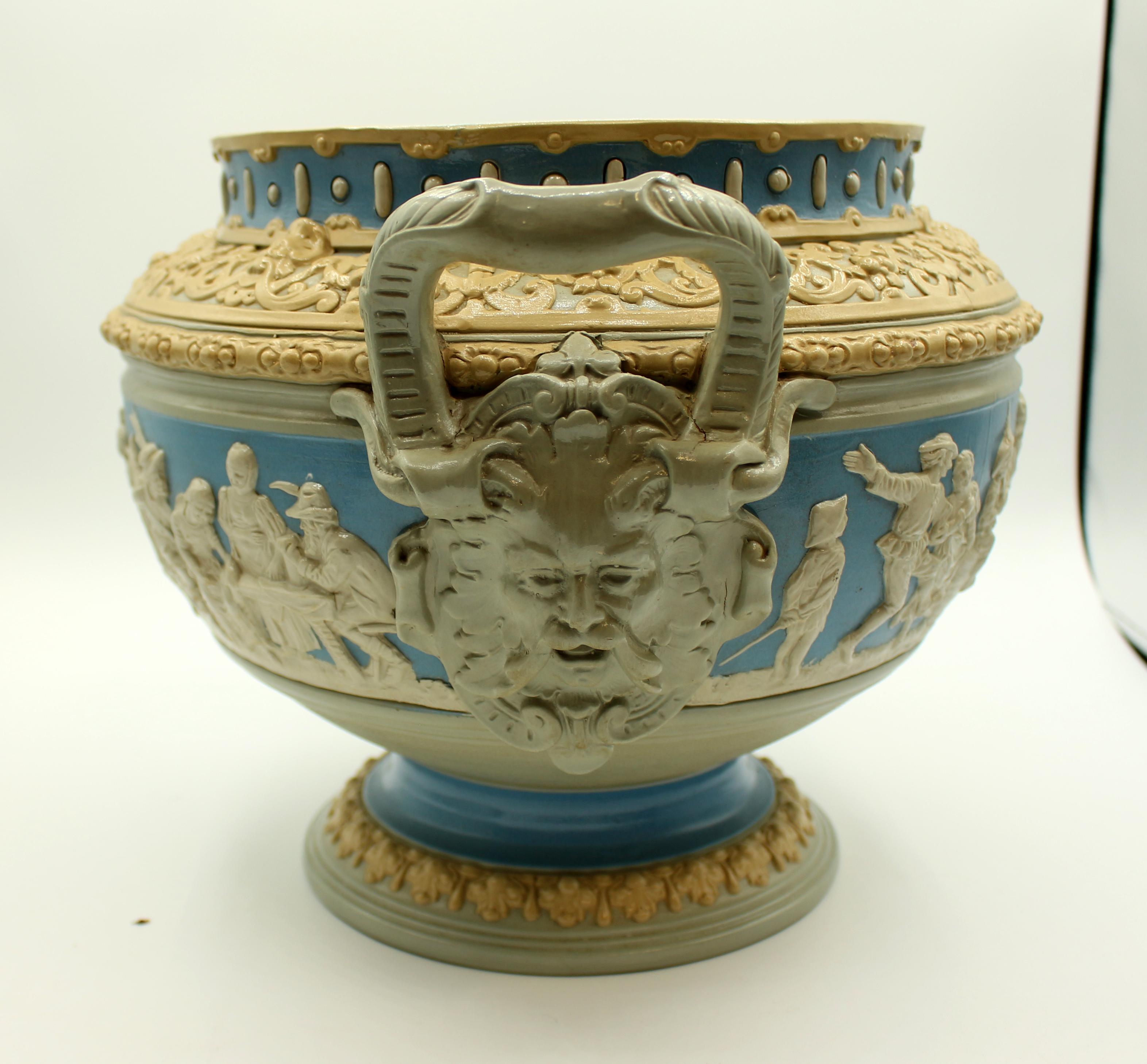 Early 20th century Mettlach stoneware punch bowl with undertray & cover. German works, #2087 with full US & German patent marks. Renaissance Revival style with German towns of note for drinking and old German phrases on stand playing on drinking