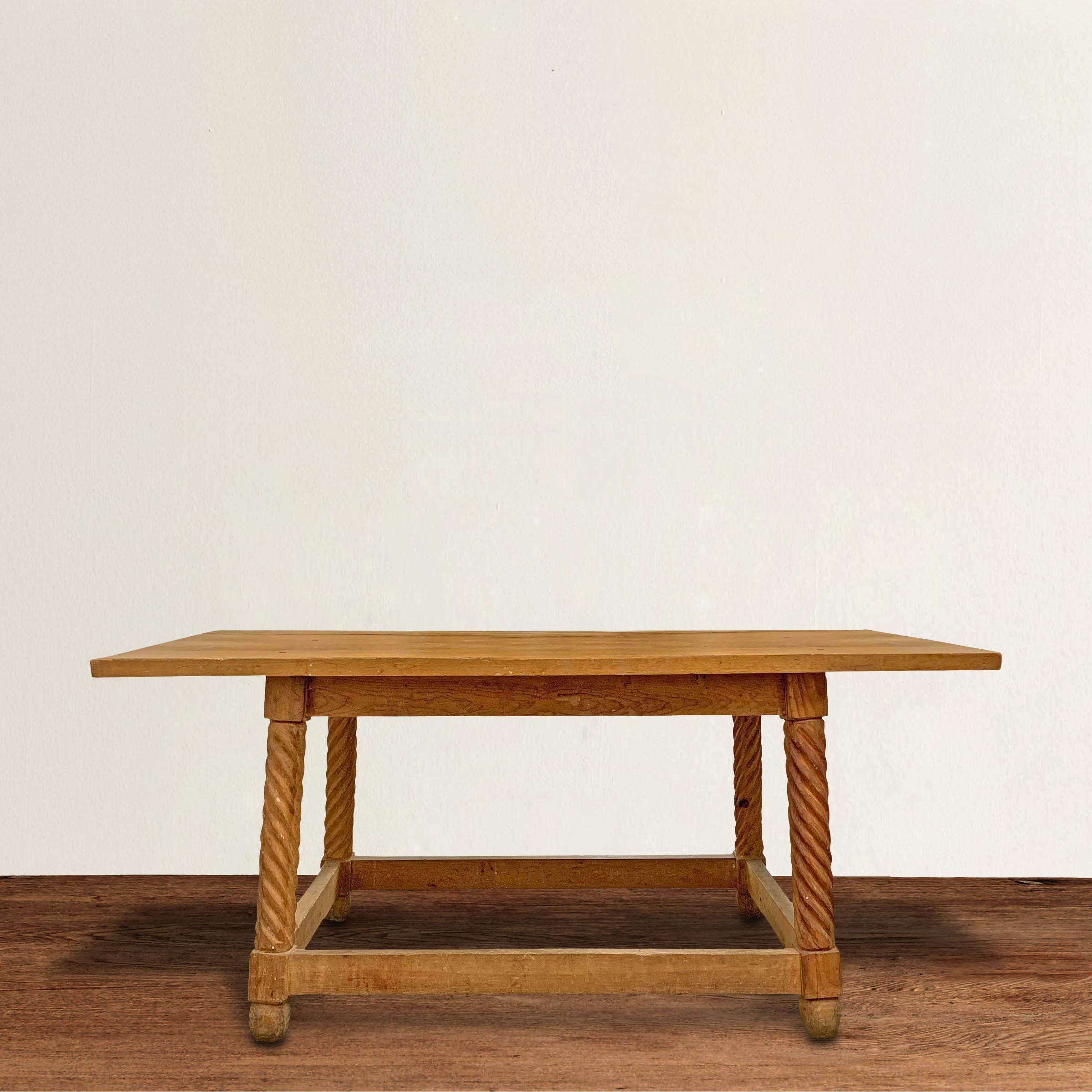 A wonderful early 20th century Mexican hand carved pine table of rectangular form with stylized tapered barley-twist legs, simple stretchers, and a top held in place by multiple square wrought iron pegs. Table would work well as a kitchen island,