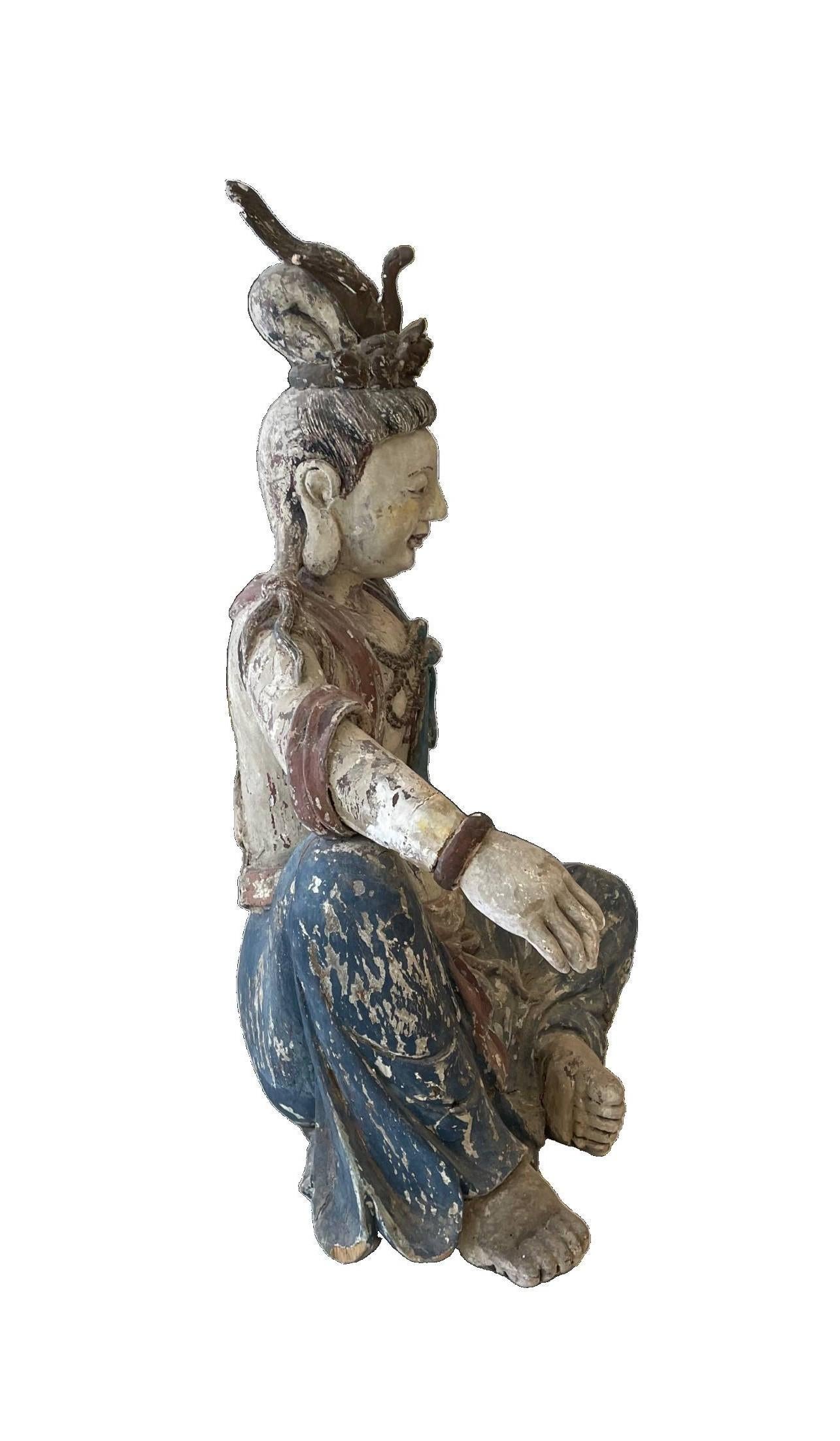 Inspired by the Ming Dynasty, this elegant statue of Guanyin, Goddess of Compassion, was hand carved in the 20th century. The artist captures the timeless and spiritual aura of Guanyin. Her flowing robes and symbolic motifs reflect ancient