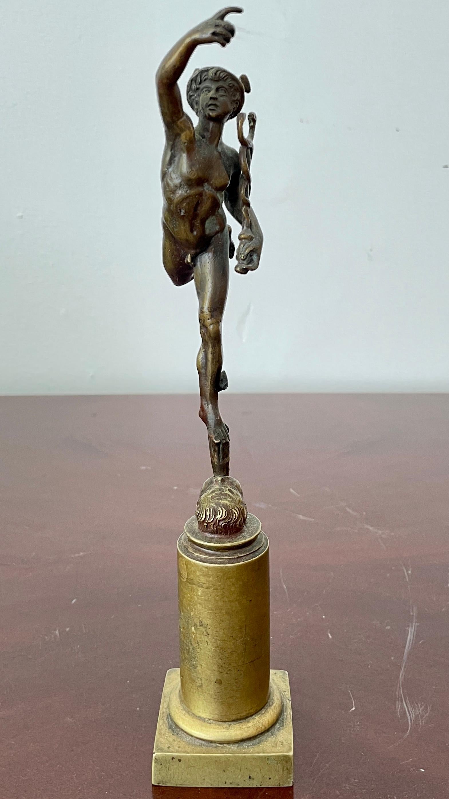 Beautiful miniature Bronze statue of Greek god Hermes carrying his staff on a pedestal base. Great addition to your classic inspired interiors and table tops.
