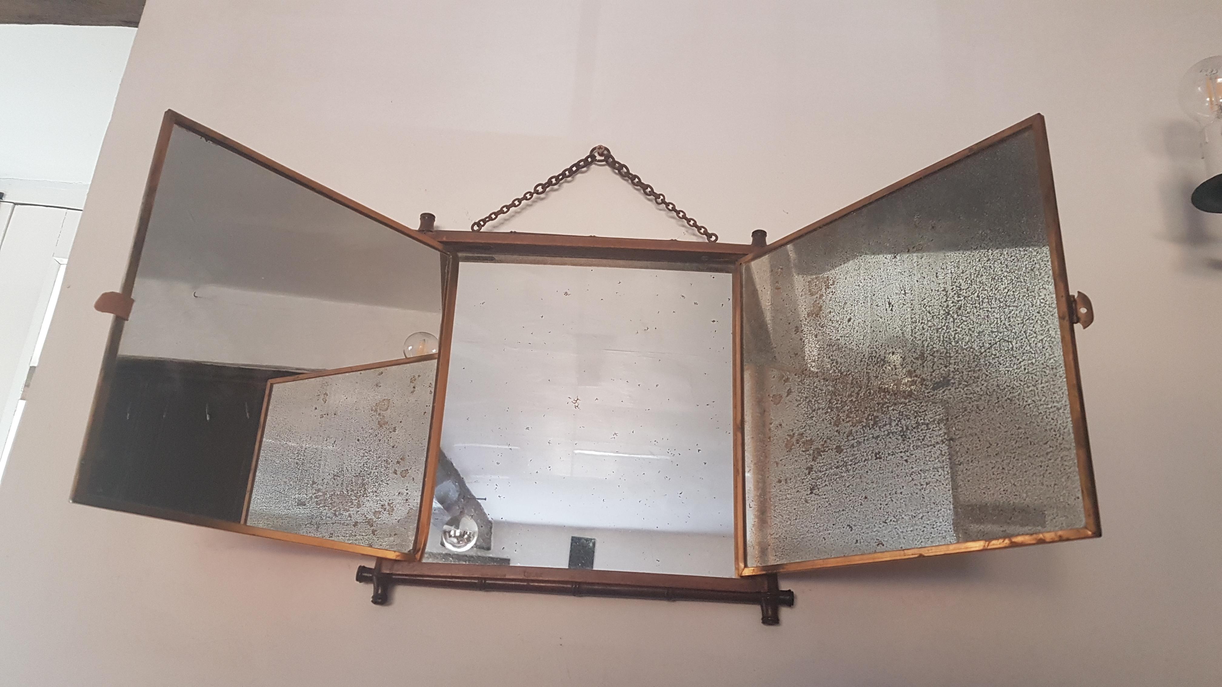 A tryptic mirror by the renowned Miroir Brot company in France. Miroir Brot invented, designed & patented this form of tryptic mechanism which at the time was very innovative. The mirror is contained within a decorative faux bamboo frame which is in