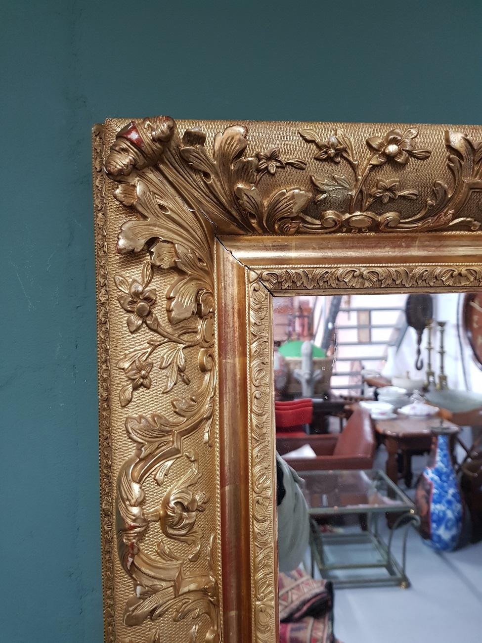 Mirror in a capital gilded frame made of wood and plaster with very light wear around consistent by age and use, early 20th century.

The measurements are,
Depth 9 cm/ 3.5 inch.
Width 54 cm/ 21.2 inch.
Height 68 cm/ 26.7 inch.