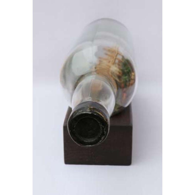A Most Interesting Early 20th Century Model Ship Diorama within Bottle.

This very well modelled and highly detailed model ship diorama within an early spirit bottle dates to circa 1920. It remarkably portrays an early 19th century three masked