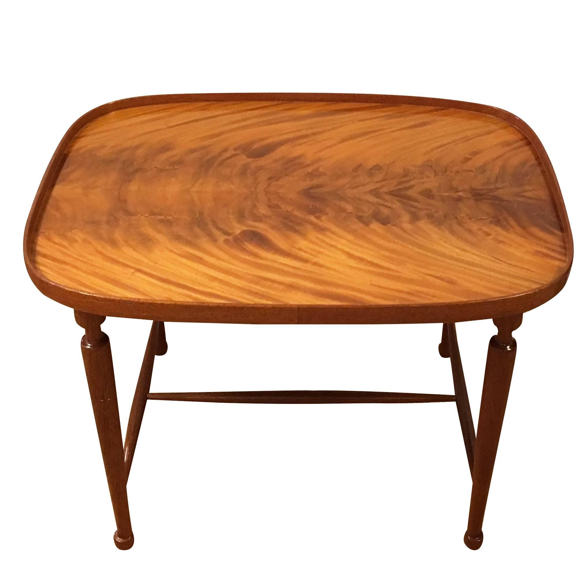 A dark-brown, vintage Art Deco Swedish coffee, sofa table made of hand crafted polished cuban mahogany wood, designed by Josef Frank and produced by Svensk Tenn in good condition. The Scandinavian side table is standing on four straight wooden legs,