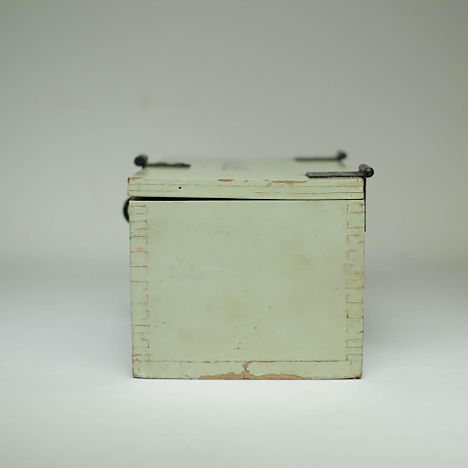 Pale green keepsake box with steel latch, hinges and handle on the other side. Monogramed on the top. Possibly a military box used in WWII.