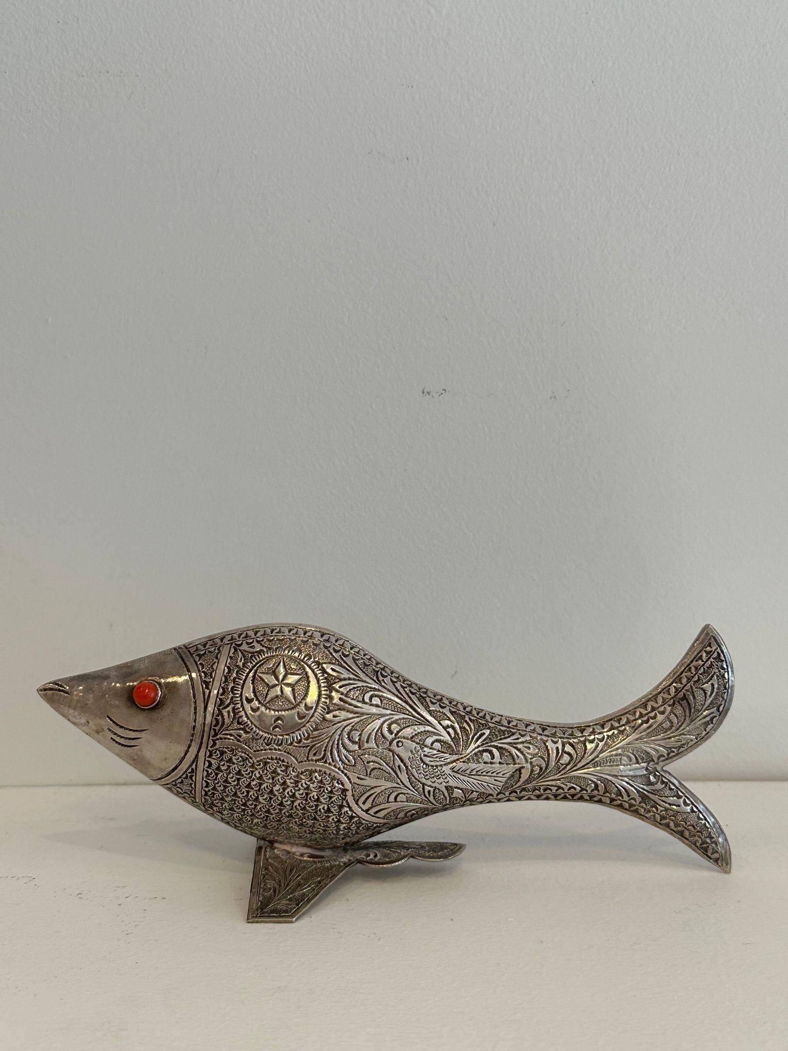 A rare, handmade standing sculptural amulet in the form of a fish. Unlike similar items that are mostly two-dimensional and are meant to be hanged only, this amulet is a standing sculpture in the round. The fish's eyes are made of coral, a gem stone