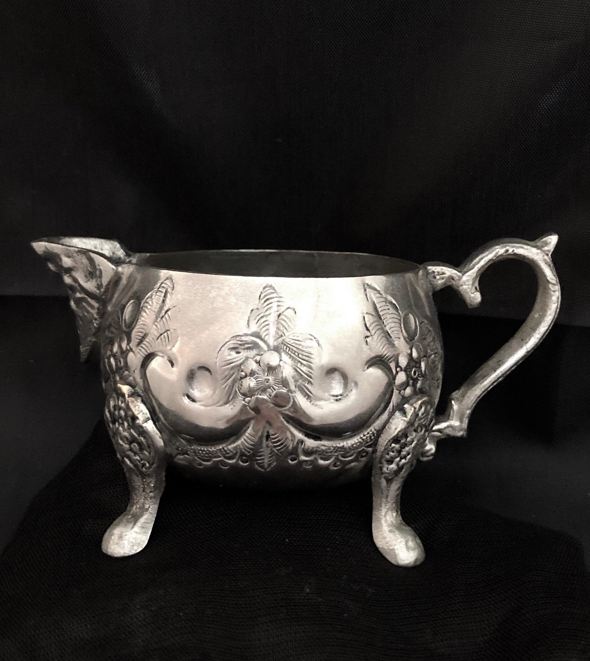 This lovely antique Moroccan silver tea sugar creamer comes from the ancient city of Fes, Morocco. Used for many generations to serve sugar (but also perfect for cream) this small round silver pitcher is beautifully decorated in repoussée and