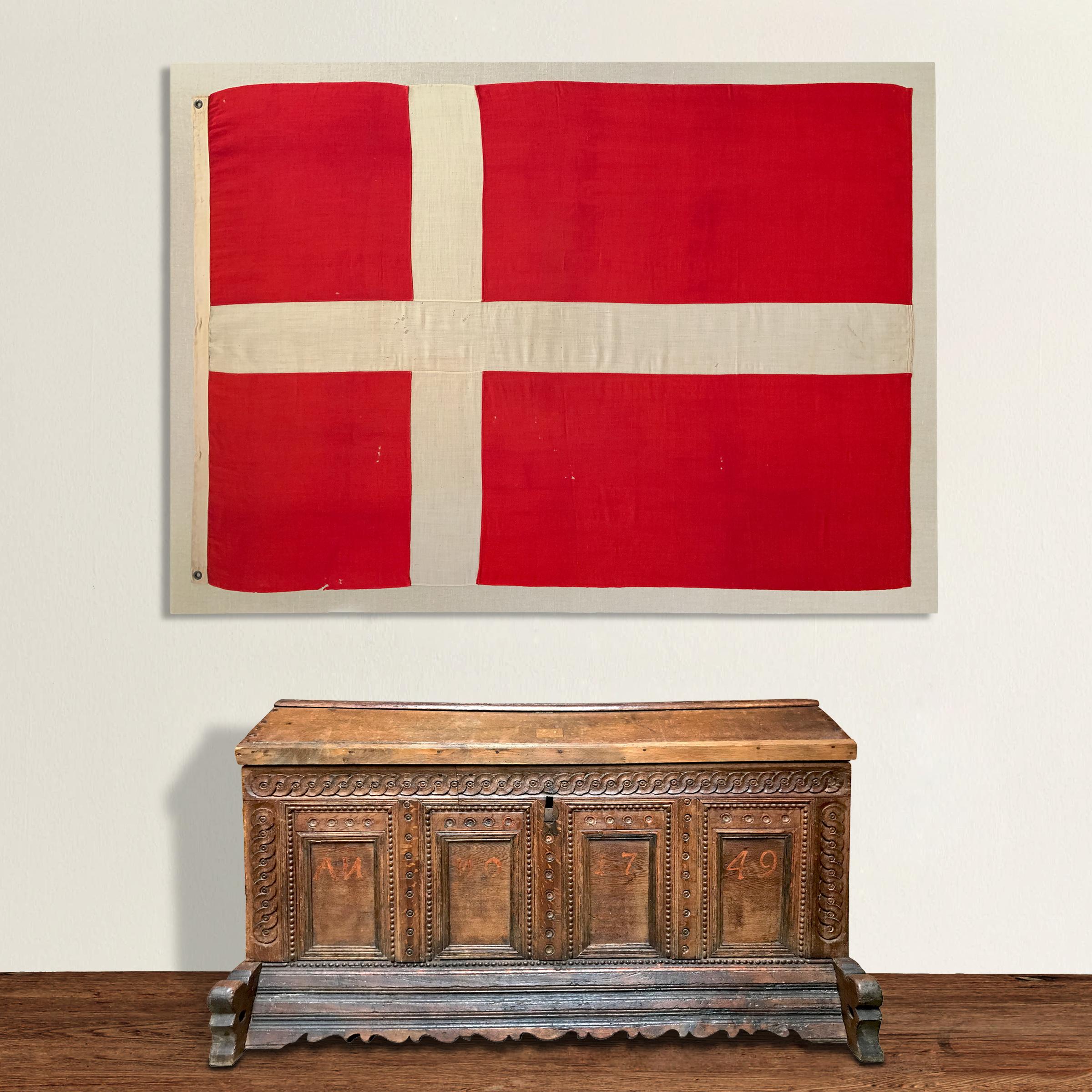 A bold early 20th century handwoven linen Danish flag, custom mounted on a Belgian linen stretcher. Can be hung vertically or horizontally.