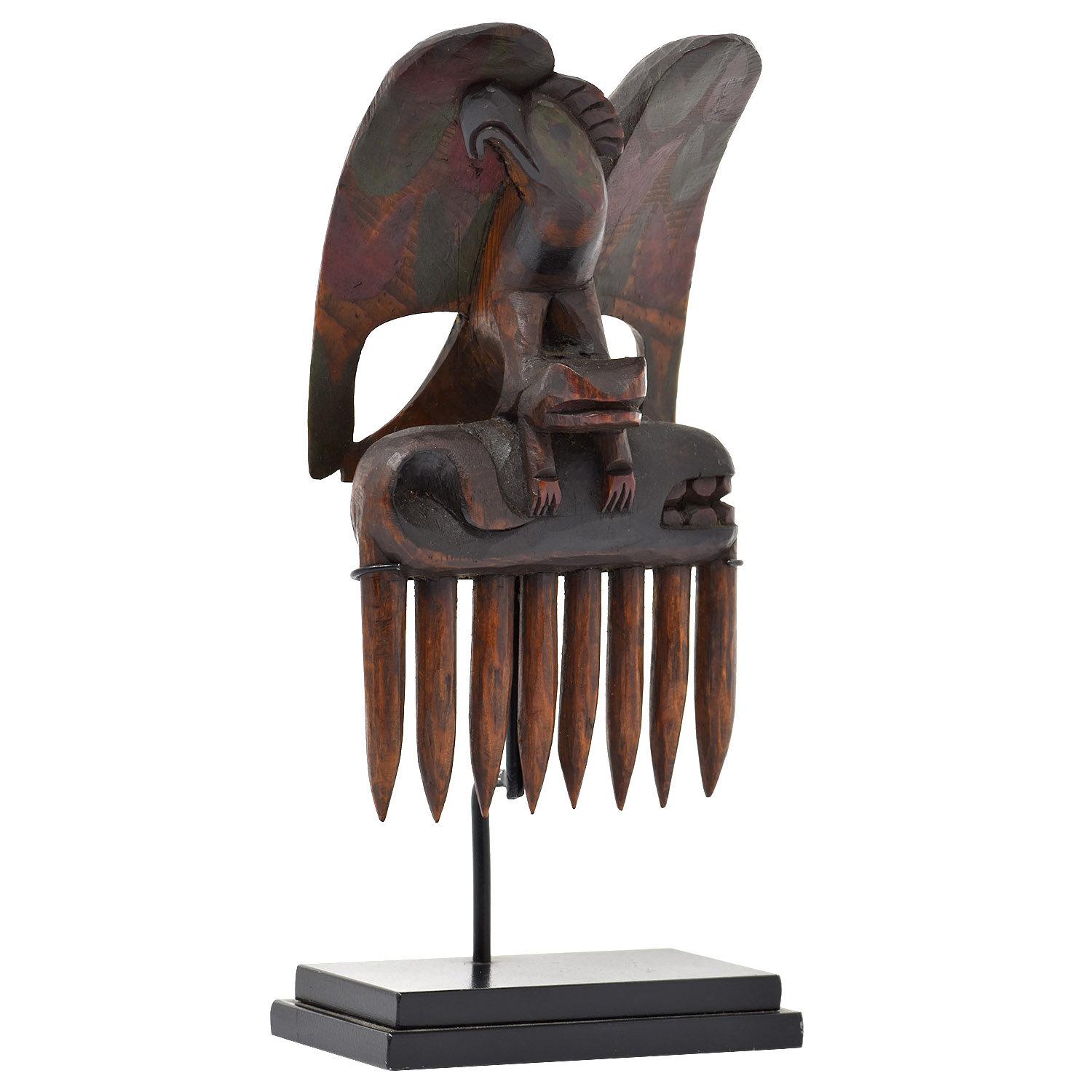 Early 20th Century Native American North West Coast Eagle Comb

The eagle has a frog in its claws which is “holding” a whale. Carved with classic North West Coast styling and motifs.

This comb has a price tag from The Olde Curiosity Shop in