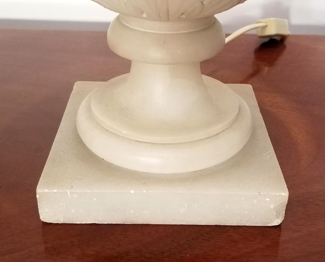 This elegantly carved Alabaster urn, with its double handles has been turned into a Campaign lamp. 

Additional measurements:
Diameter without the shade: 7.25 inches.