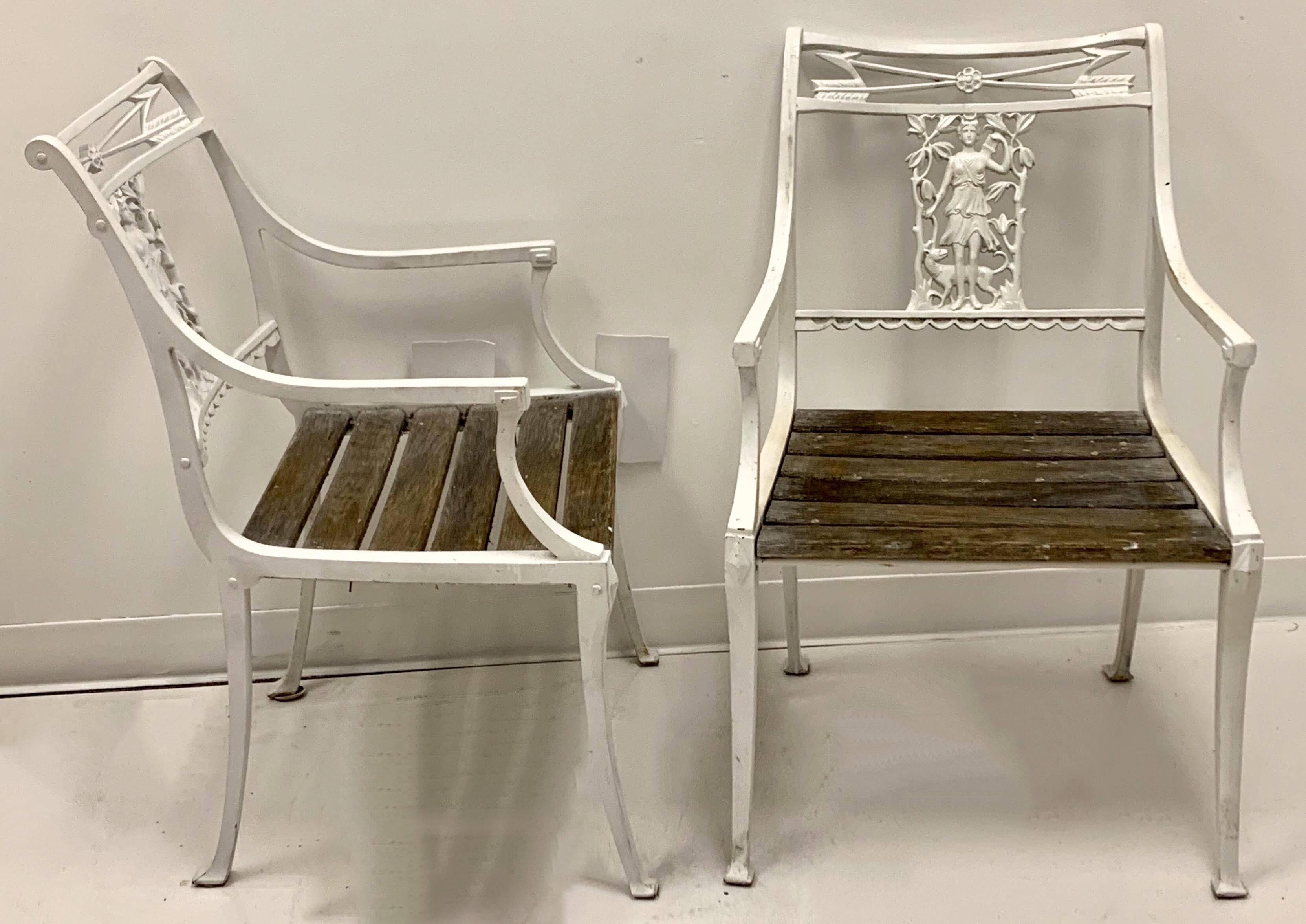 This is an early 20th century pair of neoclassical style iron chairs by the Molla Foundry, which was produced in England and New York. They have the original slats, and are in garden condition. They are extremely heavy.