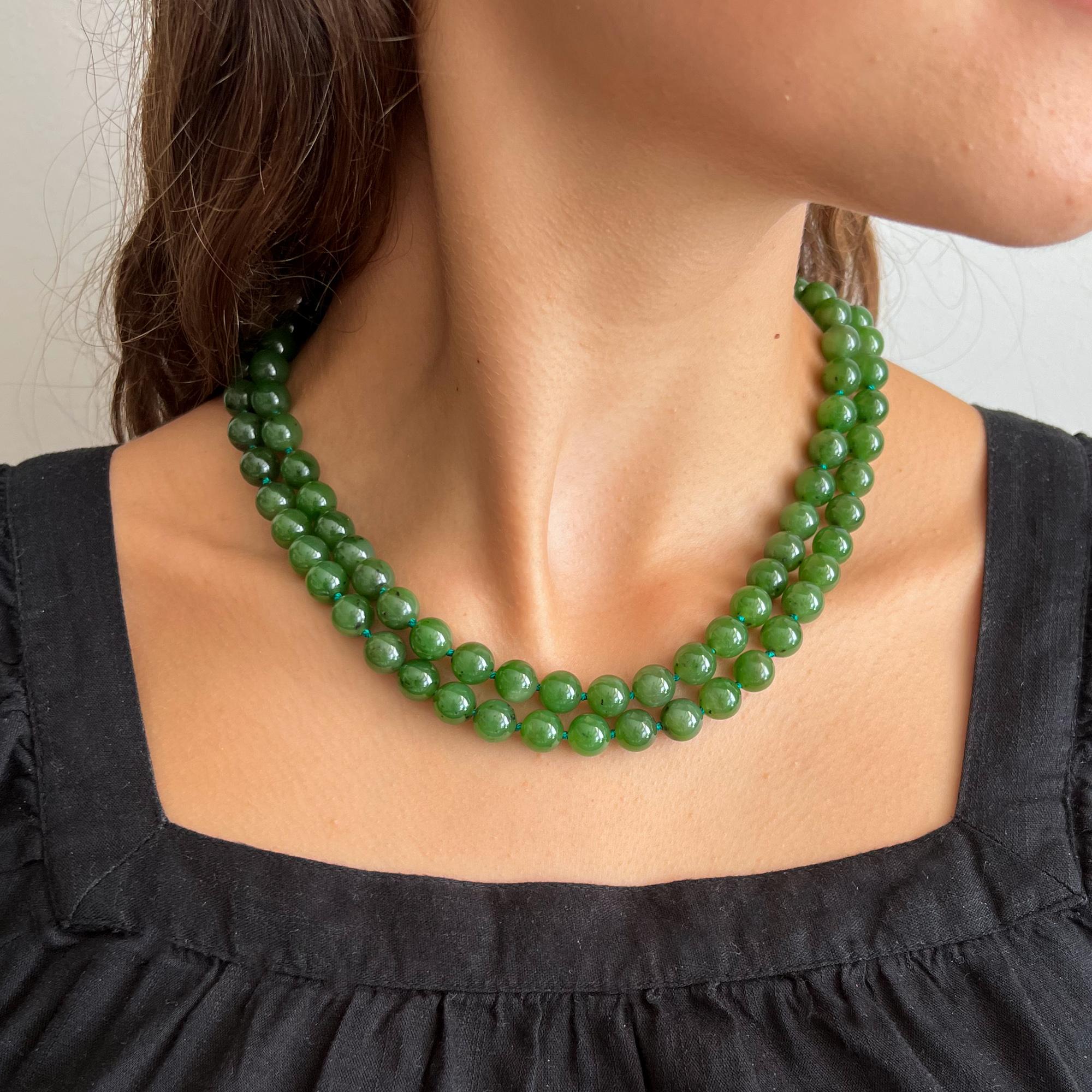 This dark green two-strand nephrite jade necklace is from Early 20th century. The necklace consists of 78 nephrite mottled jade stones. The jade strands are strung with these beautiful round beads, and to keep some nice space between the beads, the