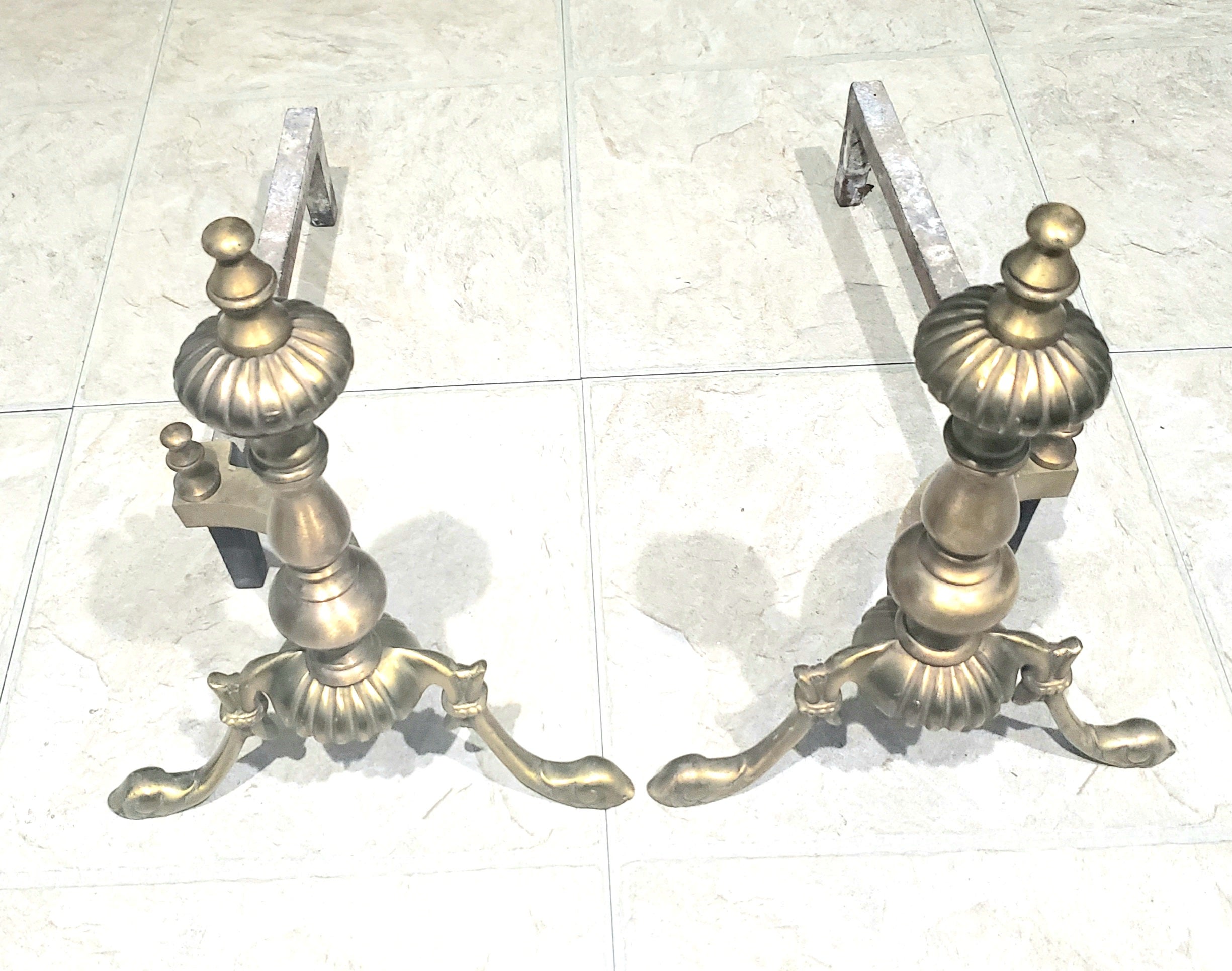Pair of new classical brass and iron andirons from 1930s. Measures 10 inches wide, 18 inches in depth and 14