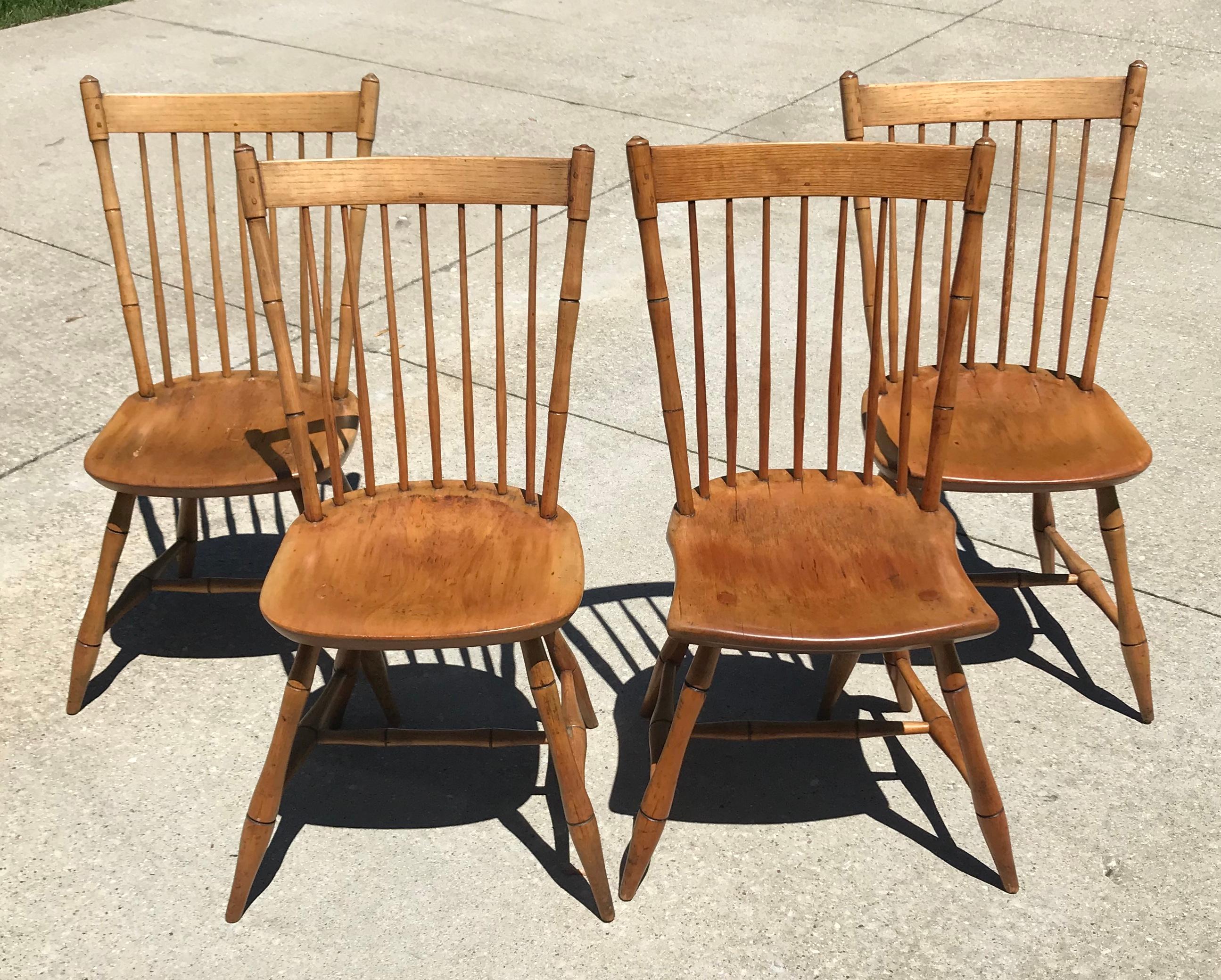 Rare find! Handsome Windsor style (set of 4) maple wood Spindleback chairs. These would be the perfect addition for small gathering table or banquet. Marked M.E. Green Mystic River Connecticut.

Please note one of the chairs seat is square and has