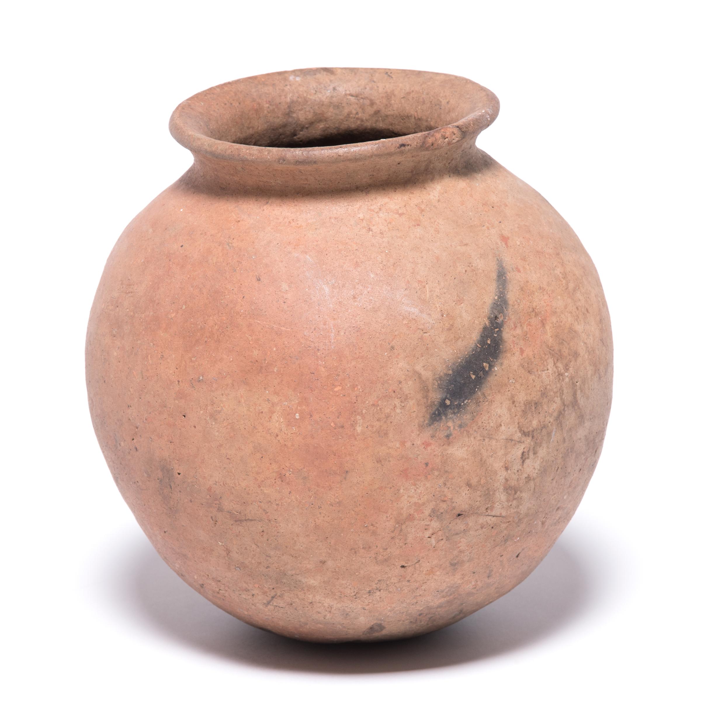 The Nupe people of Nigeria were touted as some of the finest ceramicists in Africa. Everyday objects, like this water vessel, received detailed attention. The vessel's varied textures come from its utilitarian design. The ceramicist left this vessel
