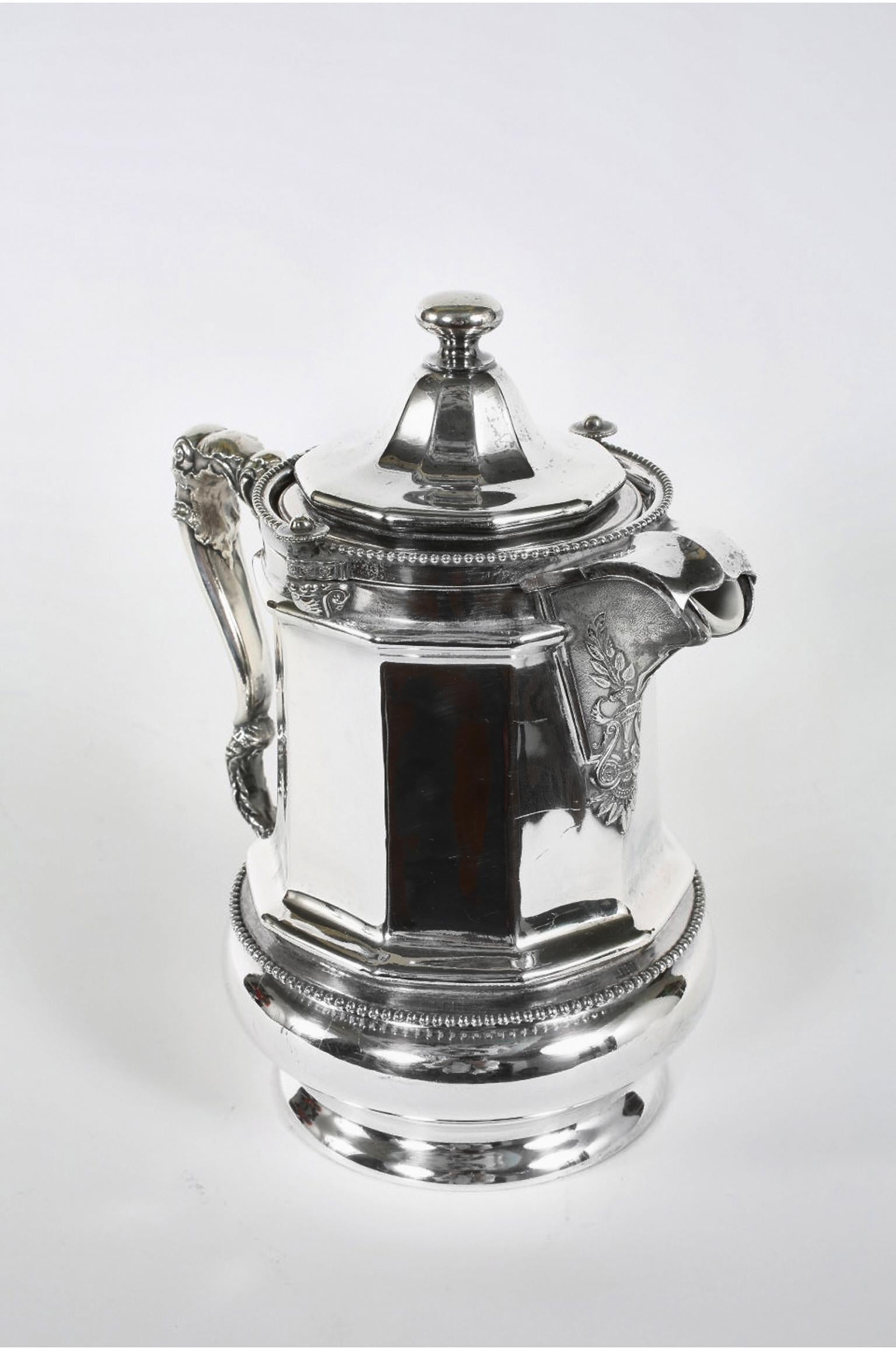 Early 20th century North American silver plated with porcelain insert interior tea / coffee pot. The tea / coffee are in great vintage condition with wear consistent with age / use. Maker's mark undersigned. The pot stand about 11.5