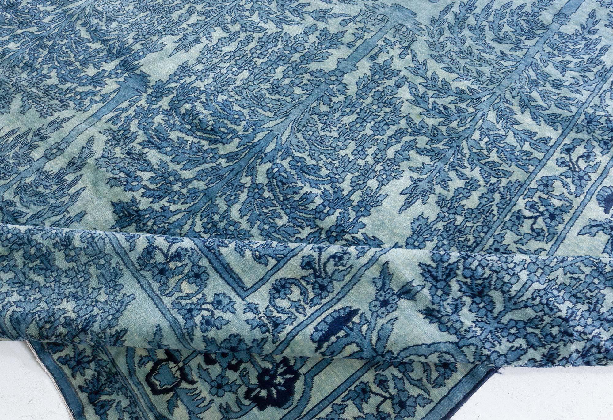 Authentic Early 20th Century North Indian blue botanic hand knotted wool rug
Size: 21'0