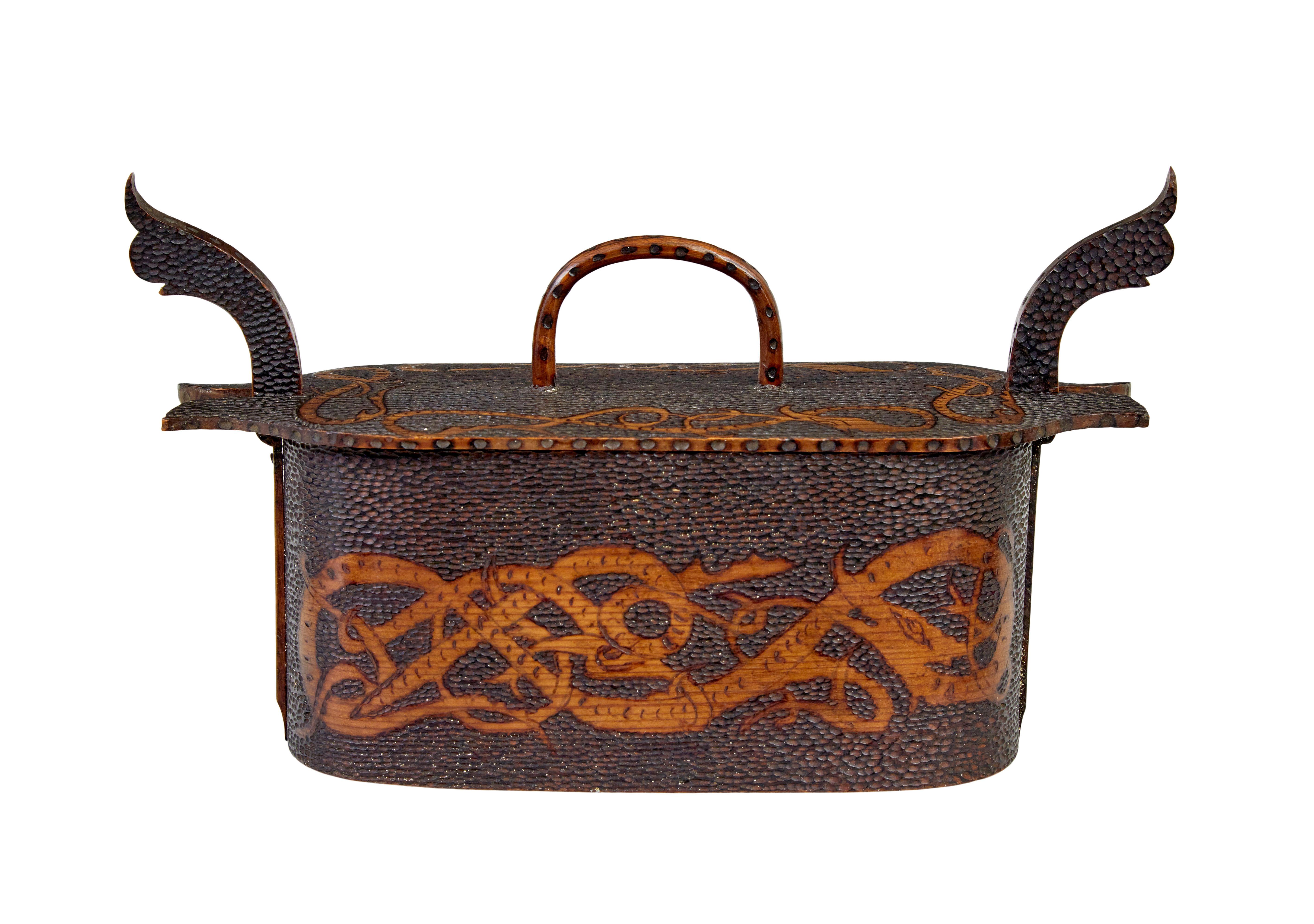 Early 20th century Scandinavian pokerwork tine box circa 1904.

Beautiful quality small Norwegian pokerwork tine box.  Stunning desktop item, with carved dragons to the sides and around the lid, echoed by the decorative heads to each end.   In