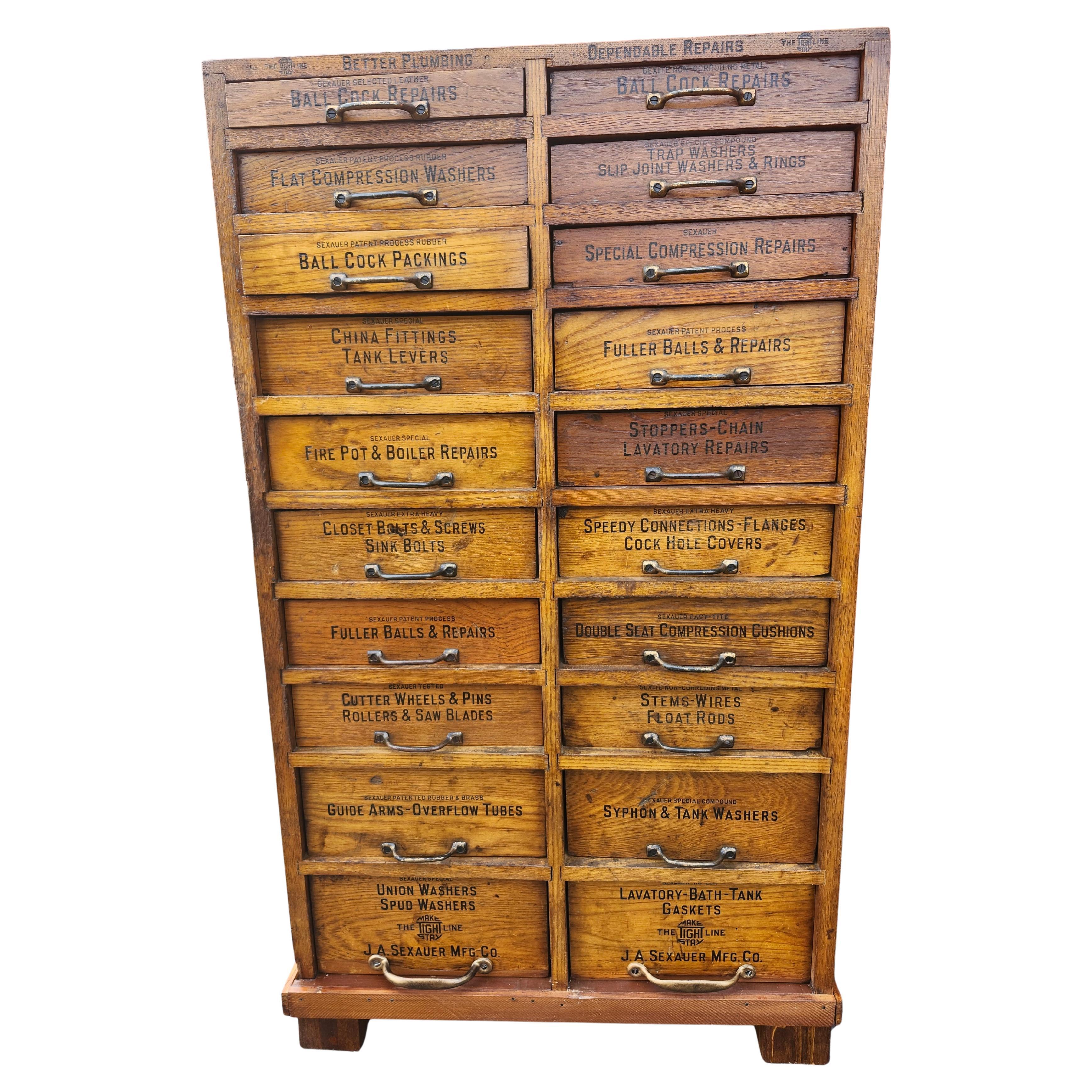 Rare and Fabulous oak 20 drawer apothecary cabinet with labeled plumbing supplies on the door fronts with Brass pulls. Created by the Sexauer co. And originally outfitted with their specific parts, which are no longer in cabinet. Pine drawers