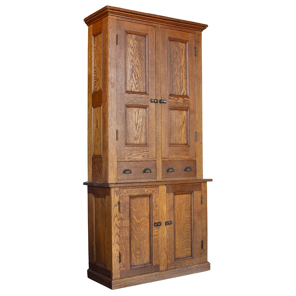 This two-piece cabinet has the width and height to provide ample storage in a classically handsome oak silhouette.