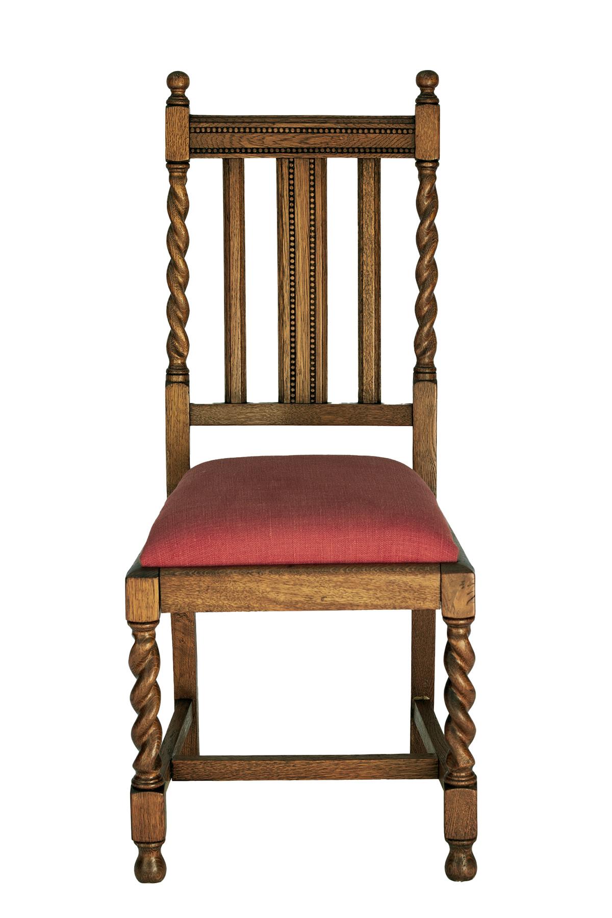 English oak side chairs with a barley corn twist & straight slats.
New seats in a linen blend in paprika red.  The legs are  connected by an H stretcher. Circa early 20th century.