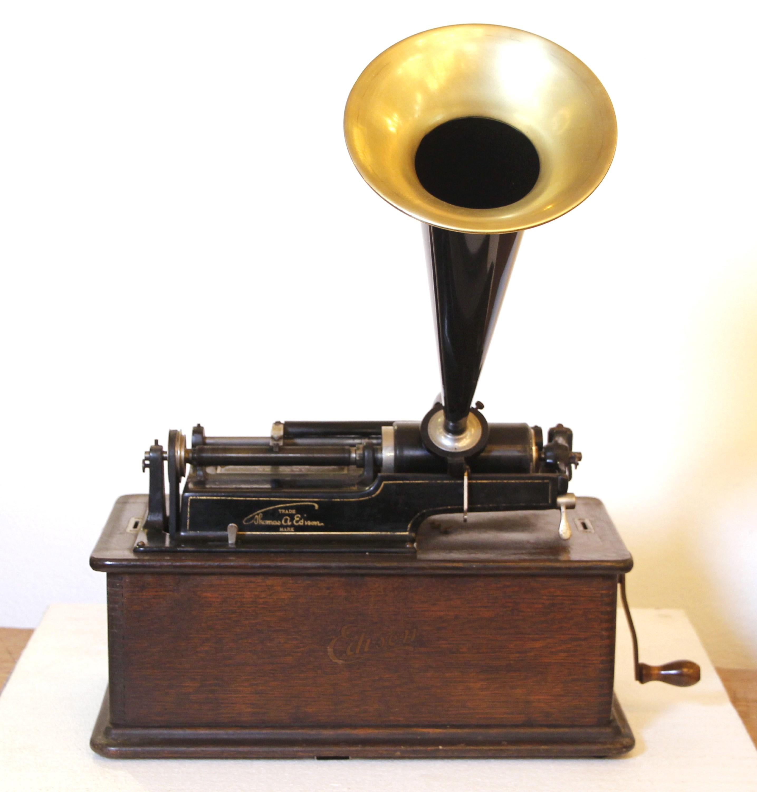 Restored and working 1900-1909 Edison Home Phonograph. Comes with 5 cylinder records which are still widely available. Original oak cabinet and case cover. Also comes with hand crank and brass edged horn. Please note, this item is located in one of