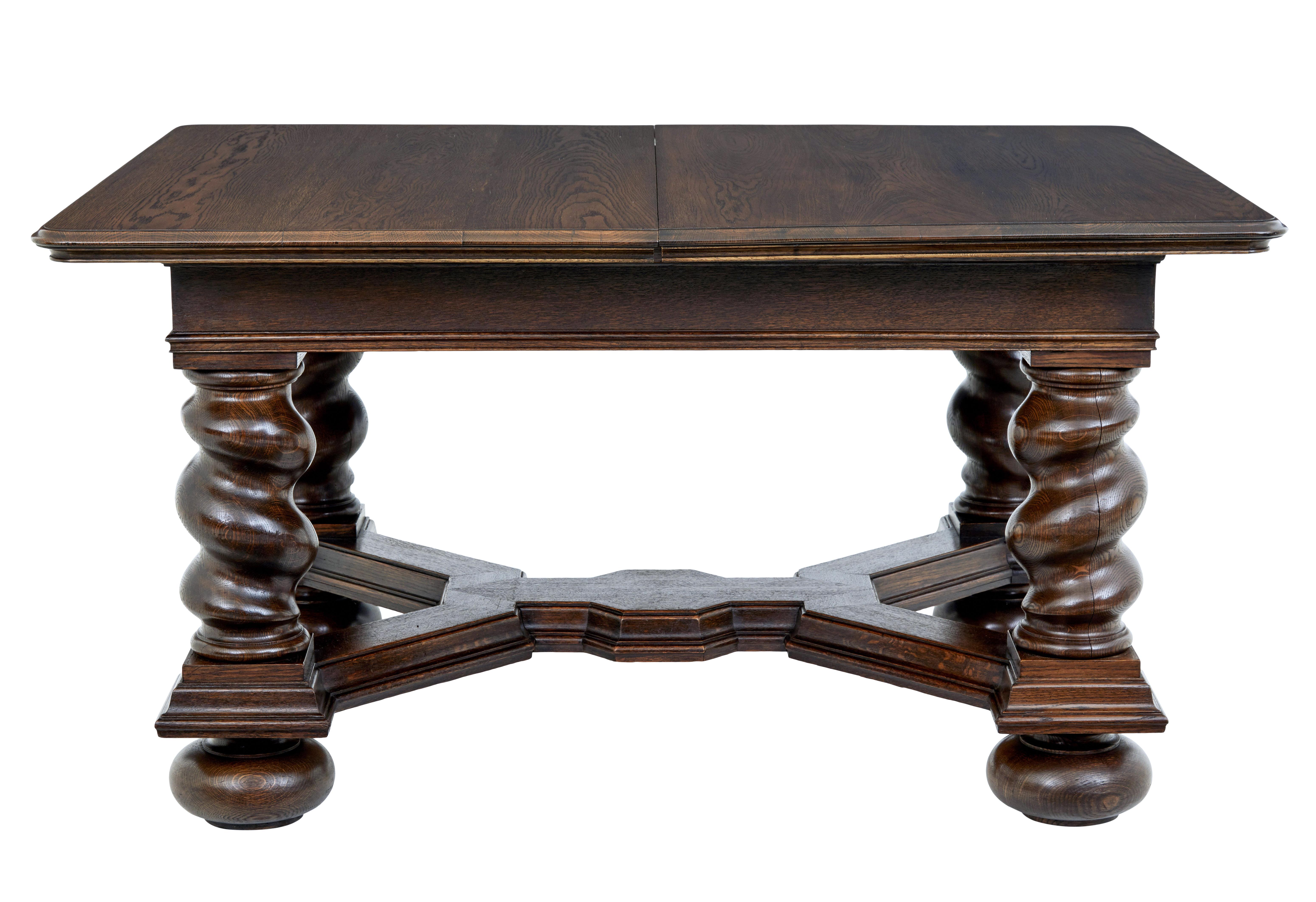 Early 20th century oak extending dining table, circa 1900.

Baroque revival table, with oak veneered top standing on a substantial base of barley twist legs united by a stretcher decorated in molding.

Supplied with 3 later leaves which have