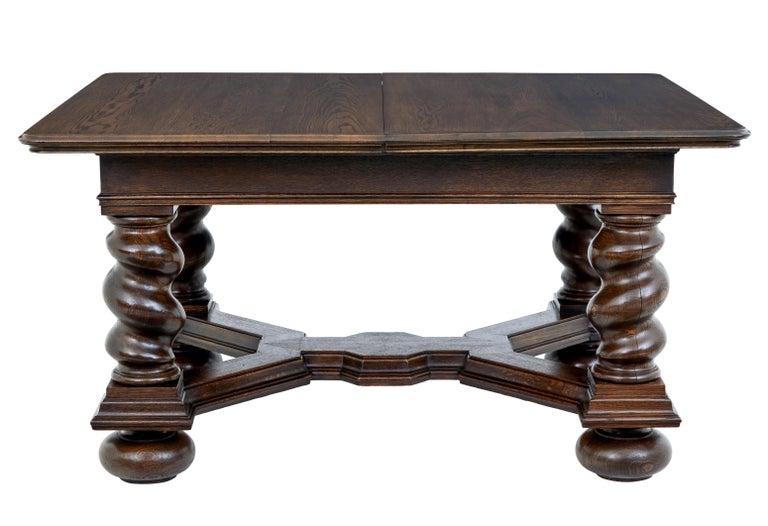 Early 20th century oak extending dining table circa 1900.

Baroque revival table, with oak veneered top standing on a substantial base of barley twist legs united by a stretcher decorated in molding.

Supplied with 3 later leaves which have been