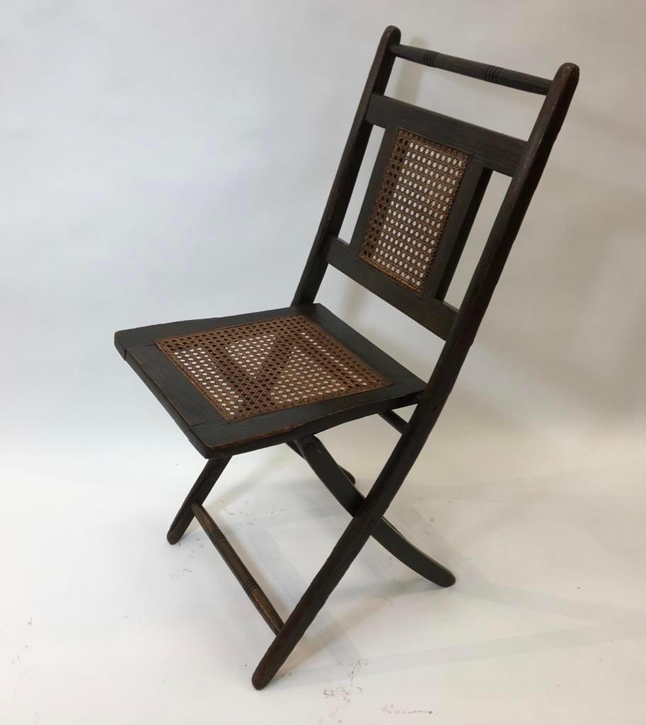 Green stained oak chair with inset caned seat and back. Stamped PECK.