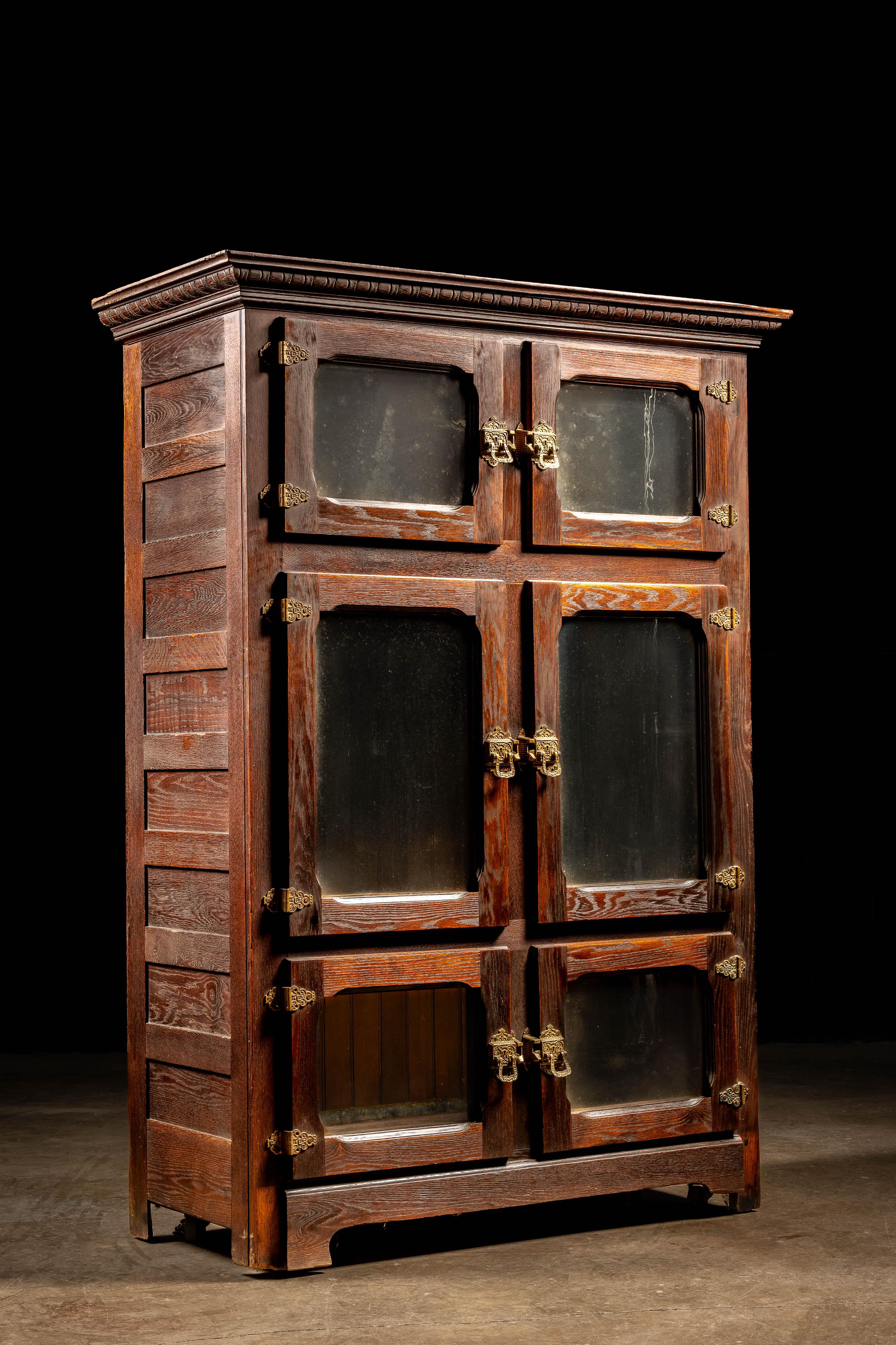 c. 1900s/1910s

Antique wooden icebox with matching oak interior paneling.

This was top of the line food storage at the turn of the century. It features a gorgeously-stained oak exterior with six double doors adorned with original ornate brass