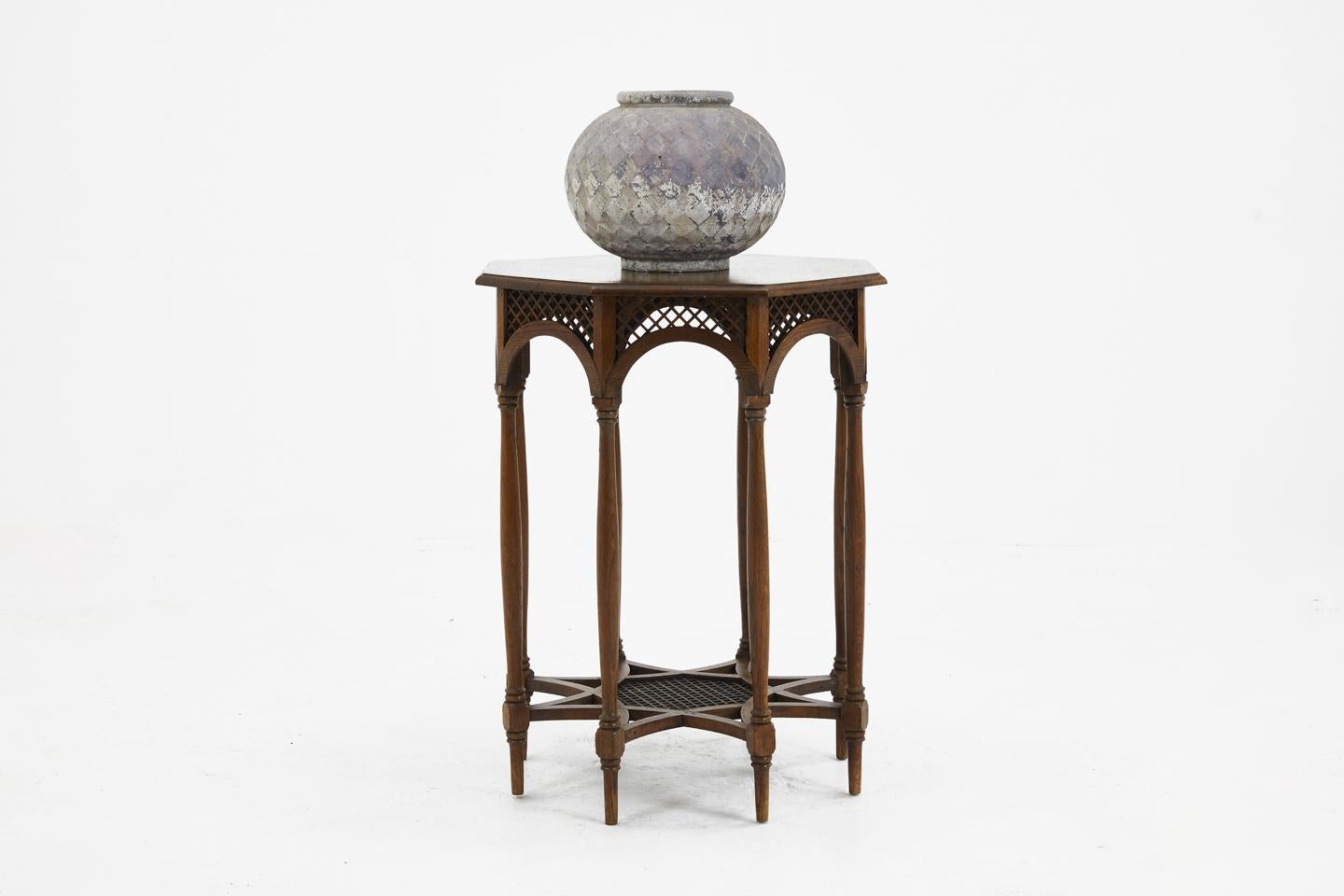 An interesting oak octagonal occasional table of nice design, with fretwork sides and base, circa 1910.